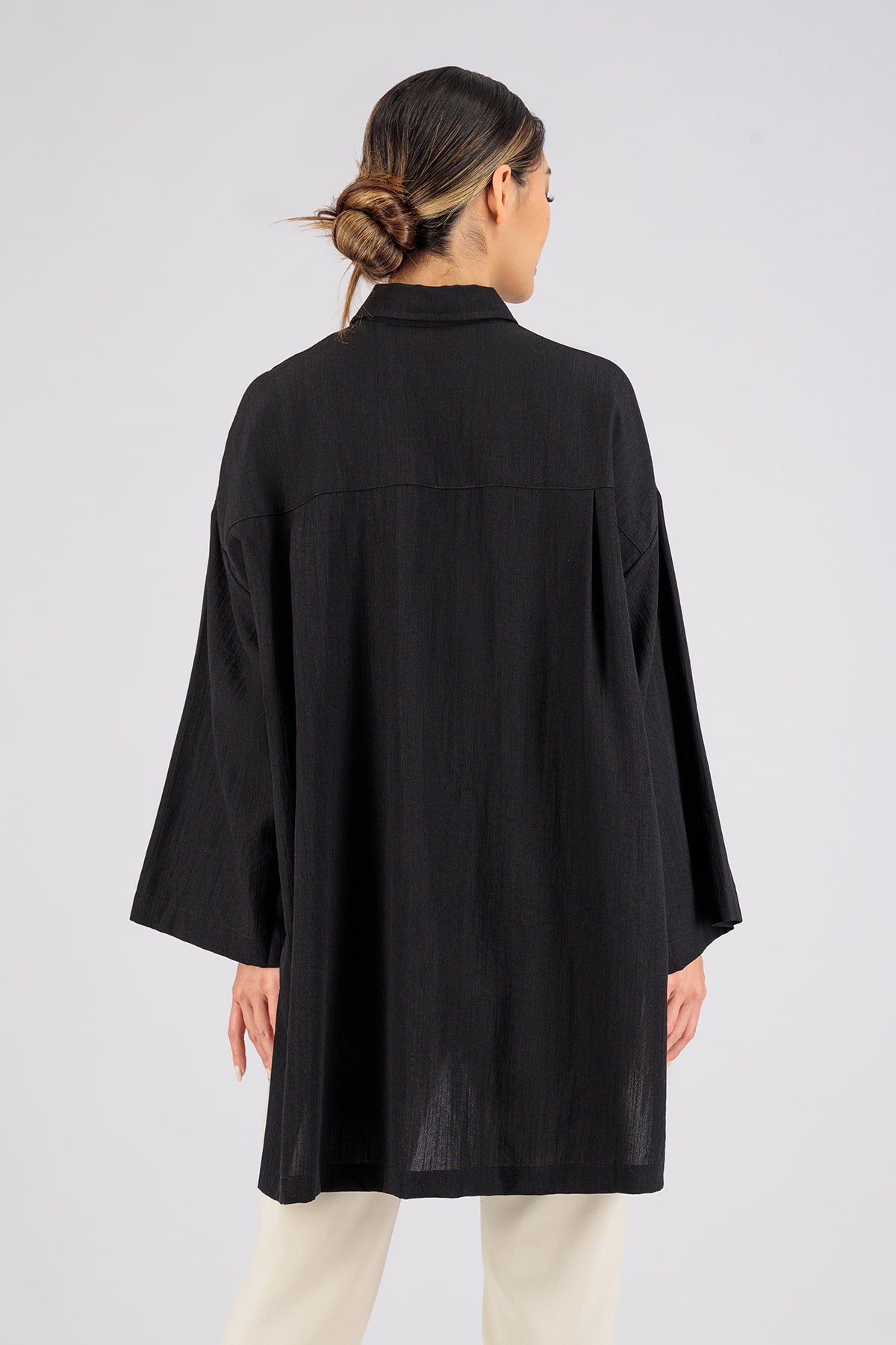 Colour: Black. A model from behind wearing a Wide Sleeve Tunic