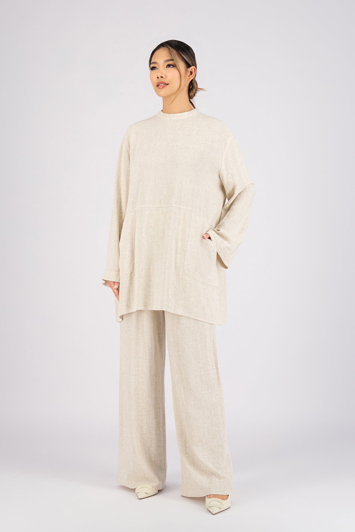 Colour: Vanilla. A model ina front pose wearing a Linen Blend Top.