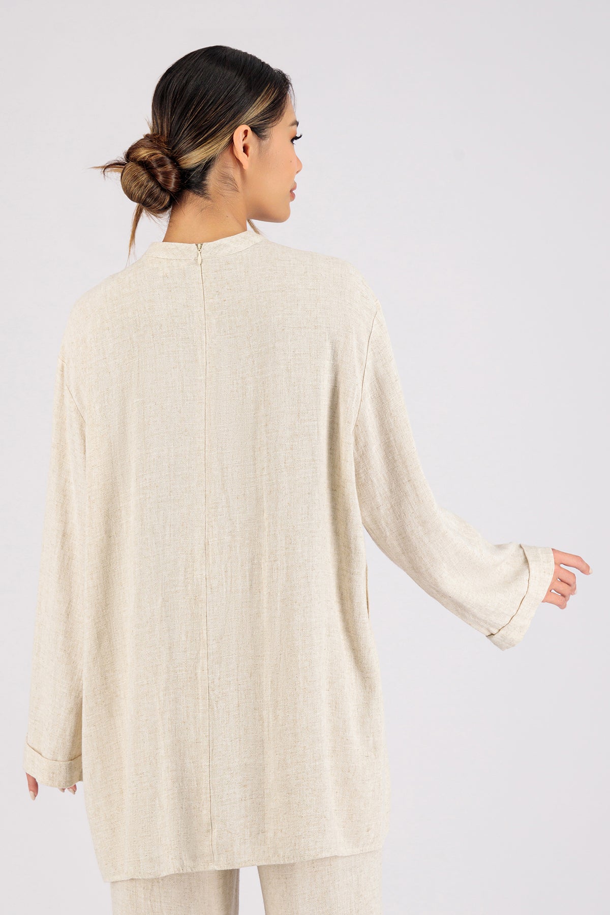 Colour: Vanilla. The back of a woman wearing a Linen Blend Top.