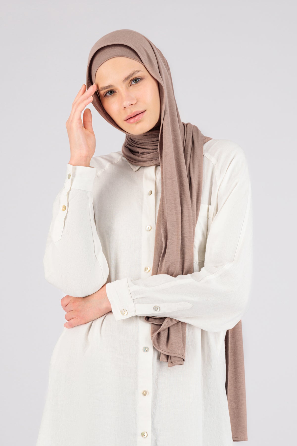 The front of a female model wearing a matching jersey hijab set. Colour description: blush pink. This set includes a modal jersey hijab and matching undercap.
