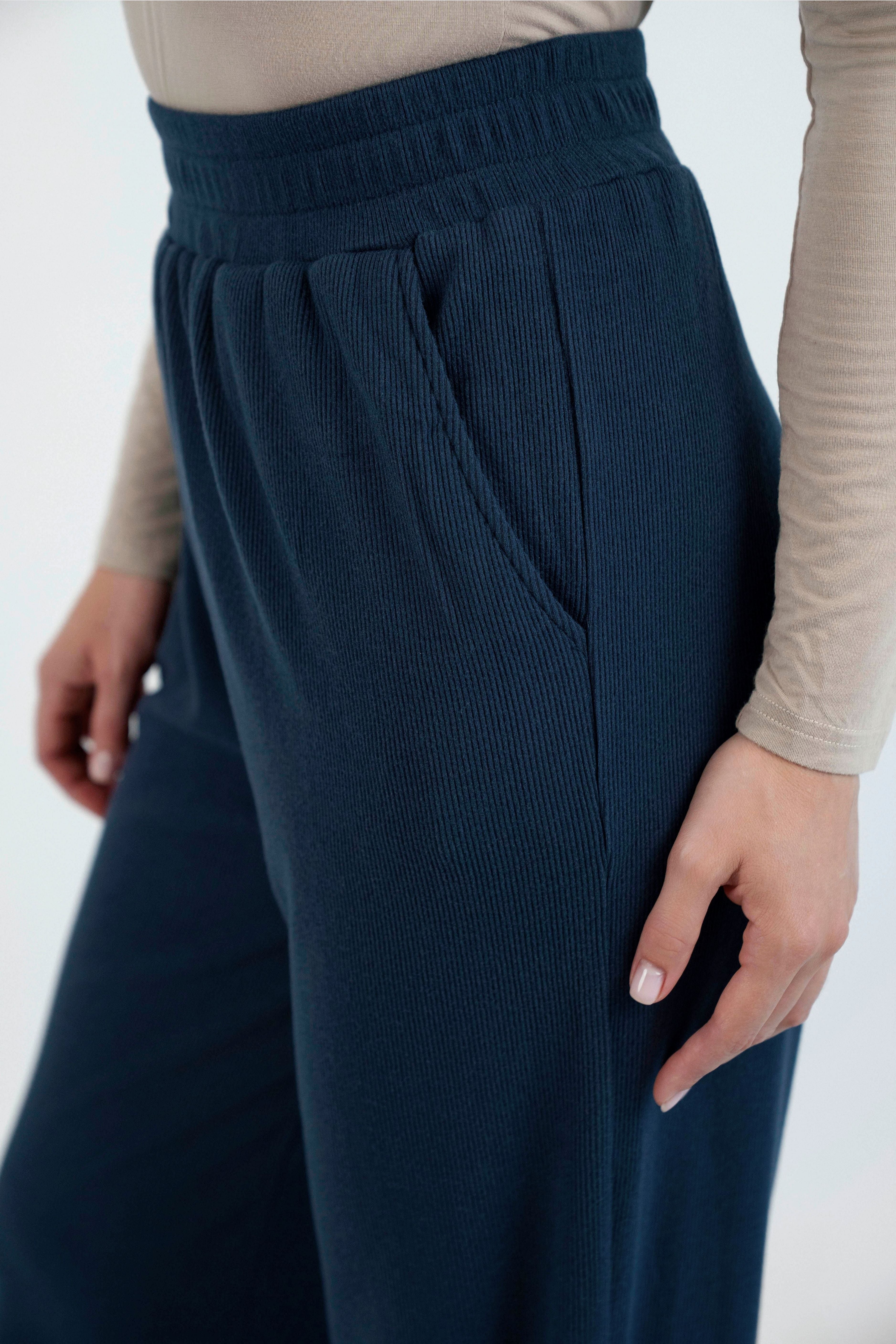 A close up of the pocket of these wide leg knit pants. Colour description: Navy Blue.