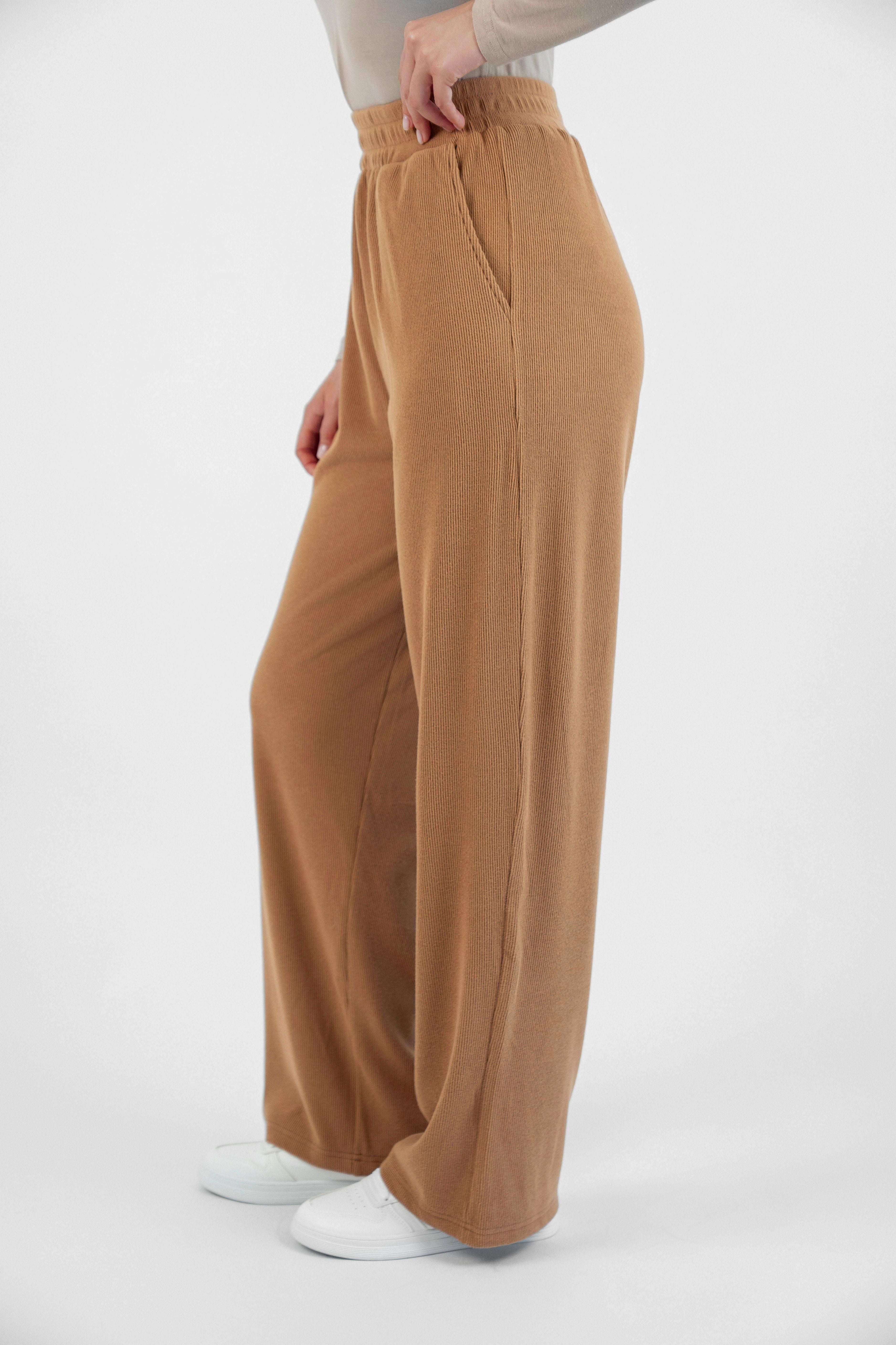 FARES' velour pants are shown from the left side. Colour description: Toffee.