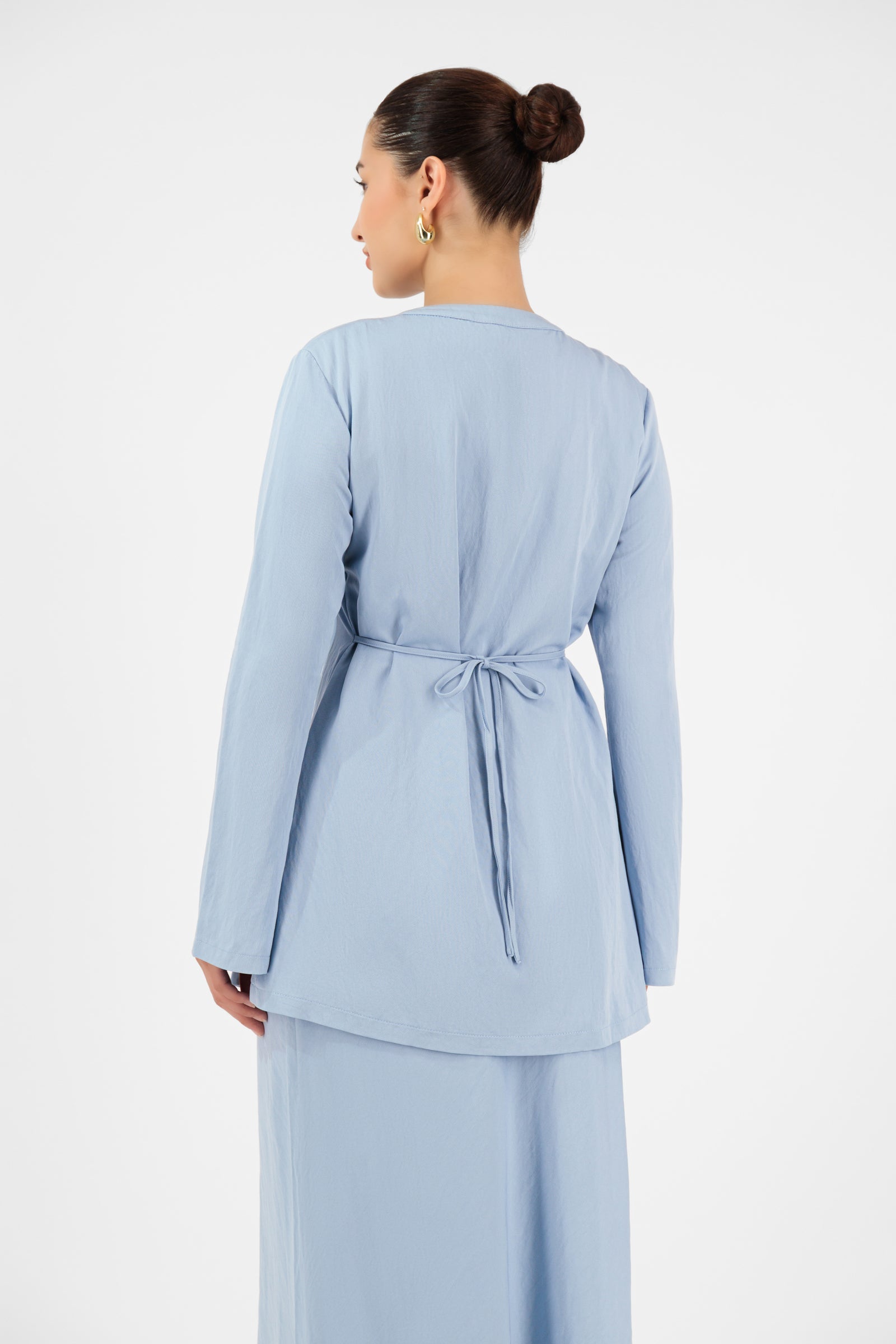 Back view of the FARES Tailored Vintage Lightweight Cardigan in Powder Blue, highlighting the longline shape and lightweight structure of this long cardigan.