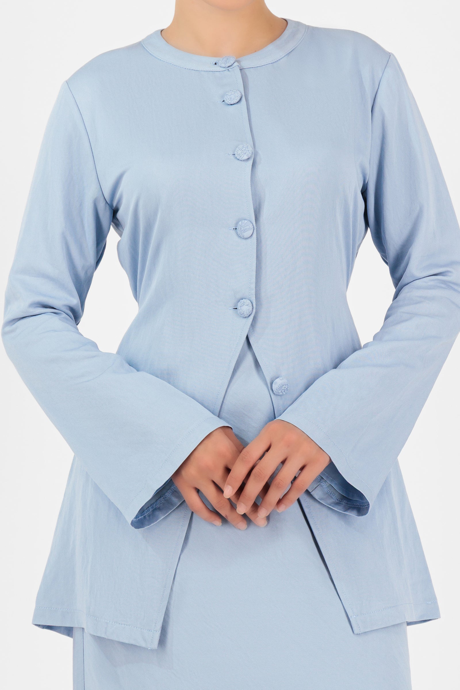 Detail of the fabric texture and button design on the FARES Tailored Vintage Lightweight Cardigan in Powder Blue.