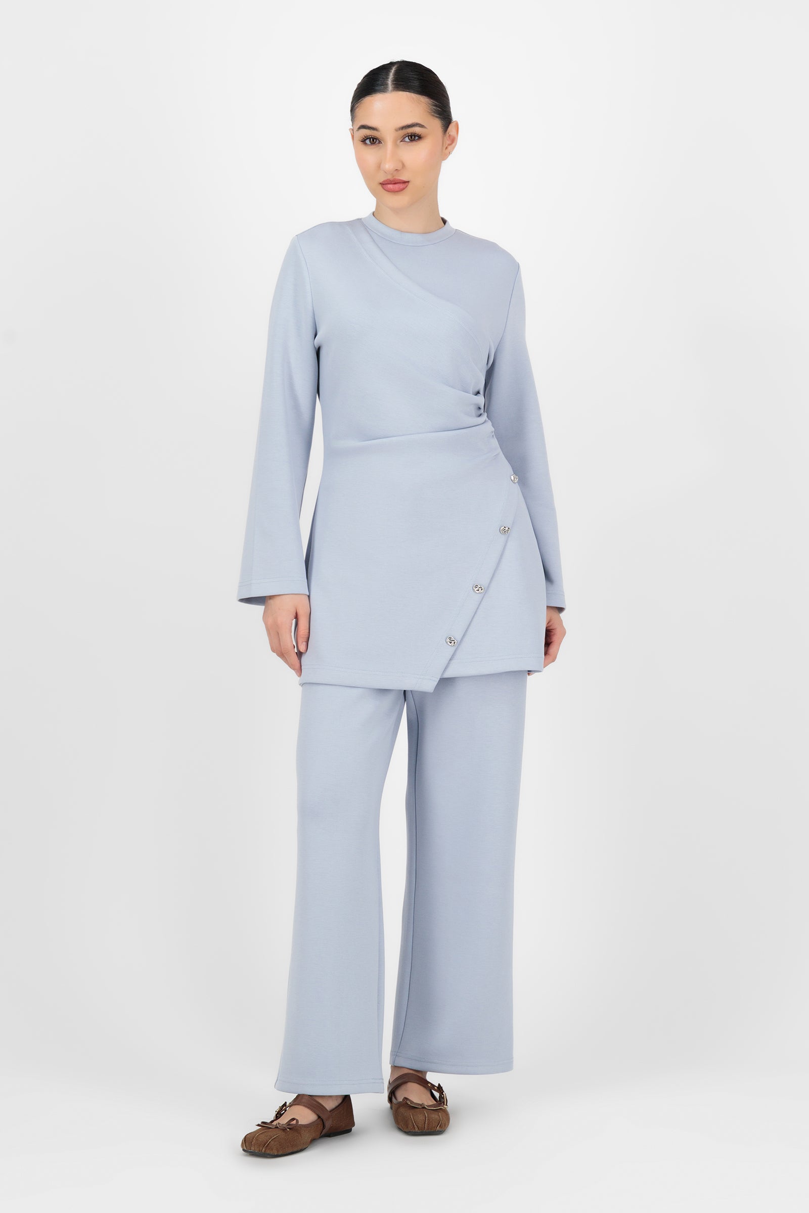 Full-body look of the model wearing the Buttery Straight Leg Trousers in Bluebell, styled simply to highlight the clean straight leg trouser silhouette.