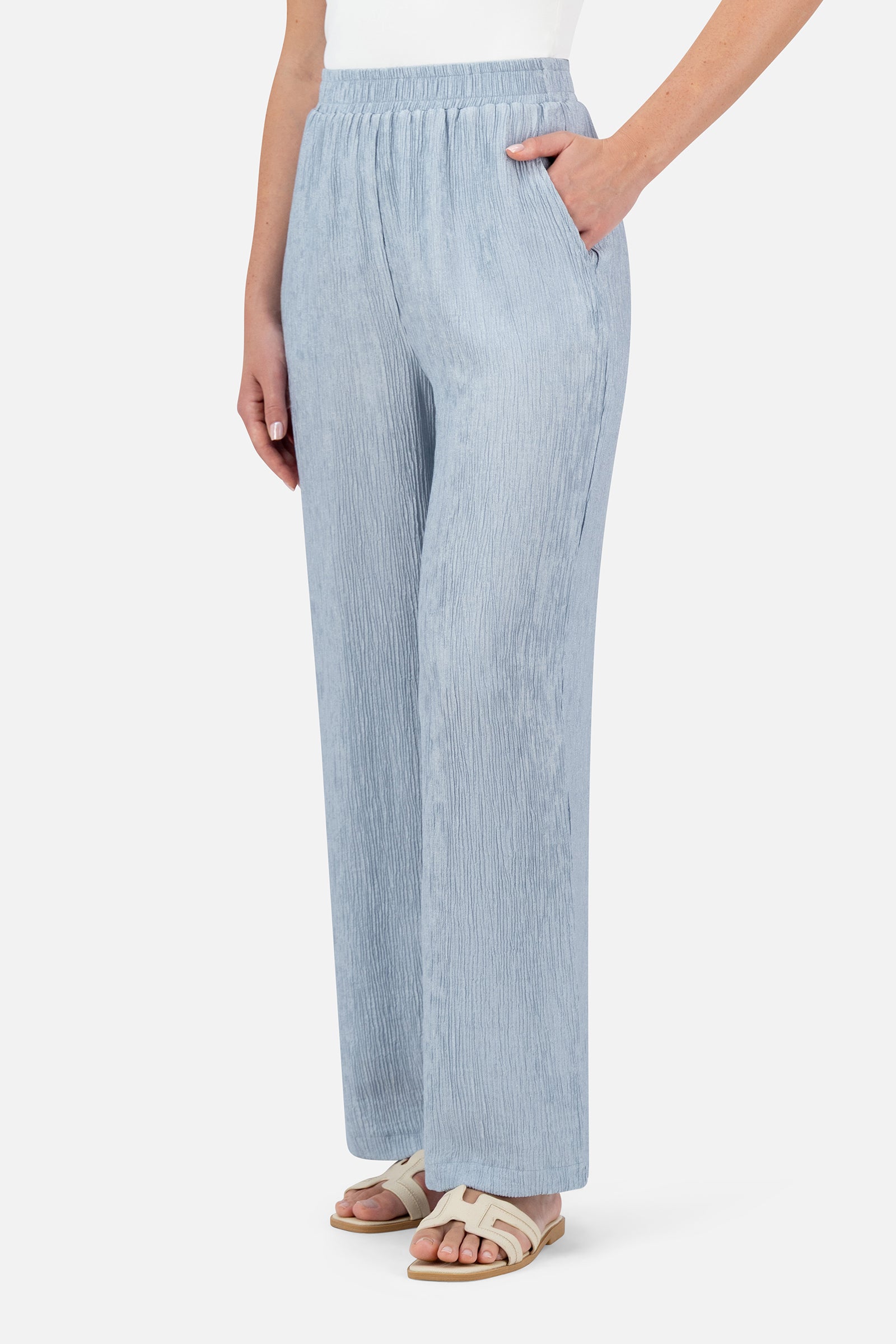 Woman standing in the Icy Blue relaxed fit pants paired with the matching bow cardigan.