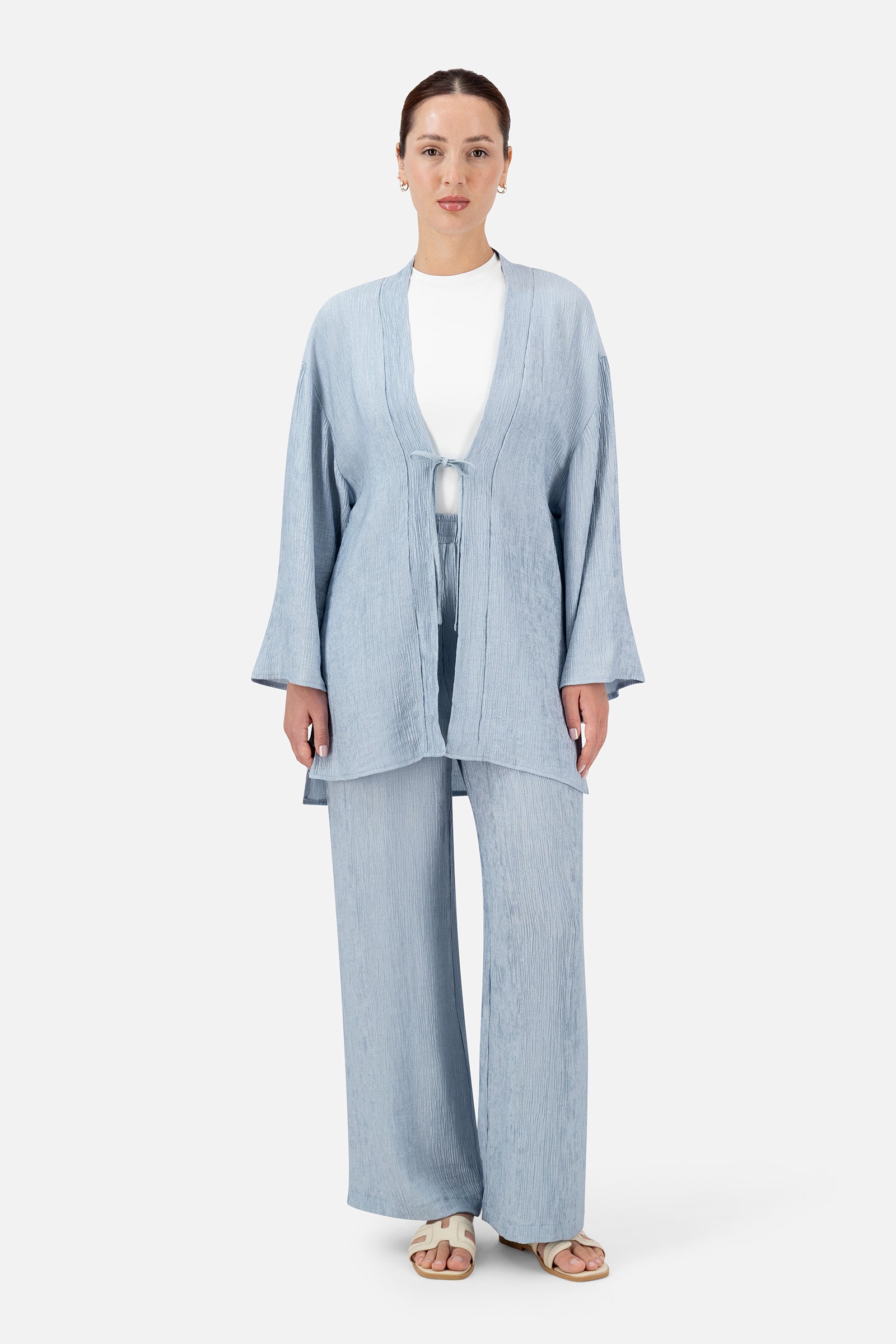 Full-length view of the model wearing the Icy Blue relaxed fit pants as part of a coordinated set.