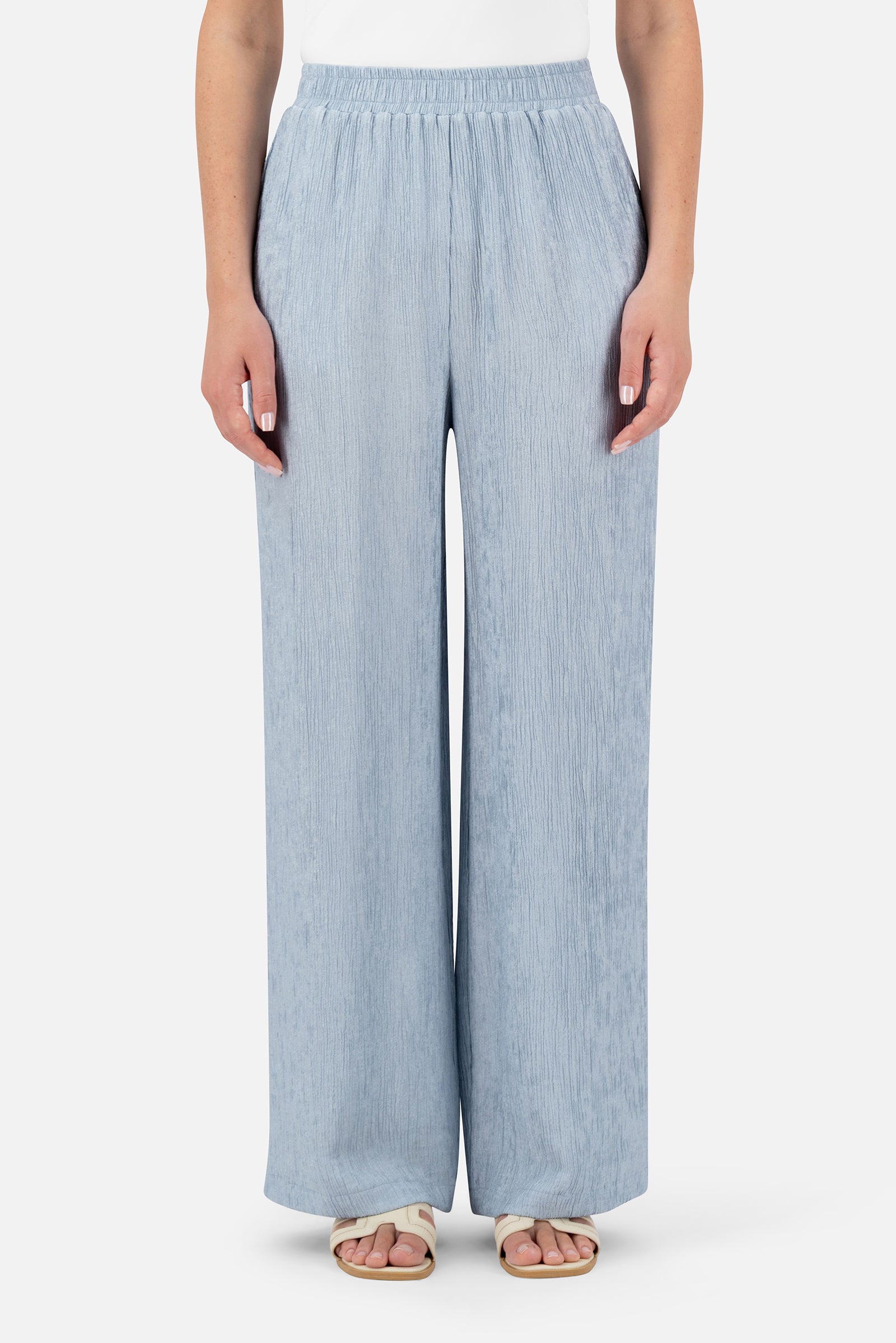 Woman wearing the Icy Blue rippled relaxed fit pants, front view with a wide-leg silhouette.