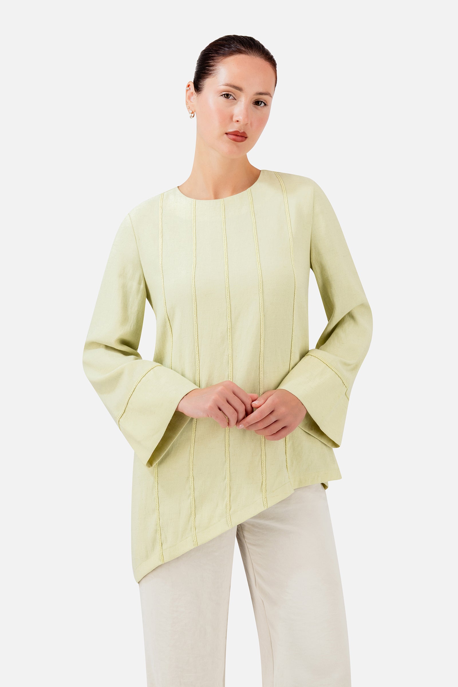 FARES Braid Detail Slanted Tunic in Honeydew shown at an angle, highlighting the soft drape, braid details and slanted hemline.