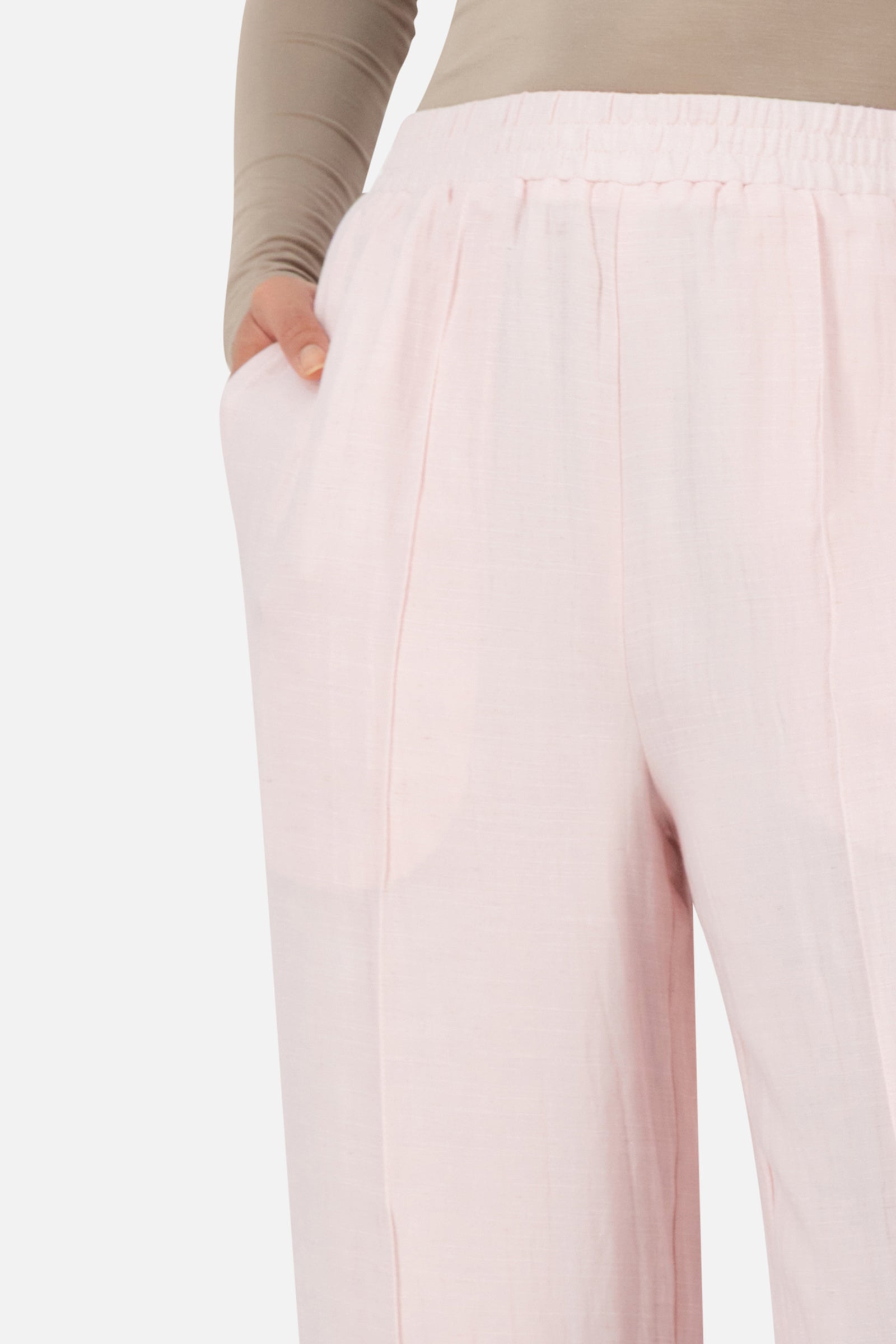 Close-up of the FARES Straight Leg Flowy Pants in Strawberry Cream highlighting the elegant drape and refined seam detailing of the straight leg pants.