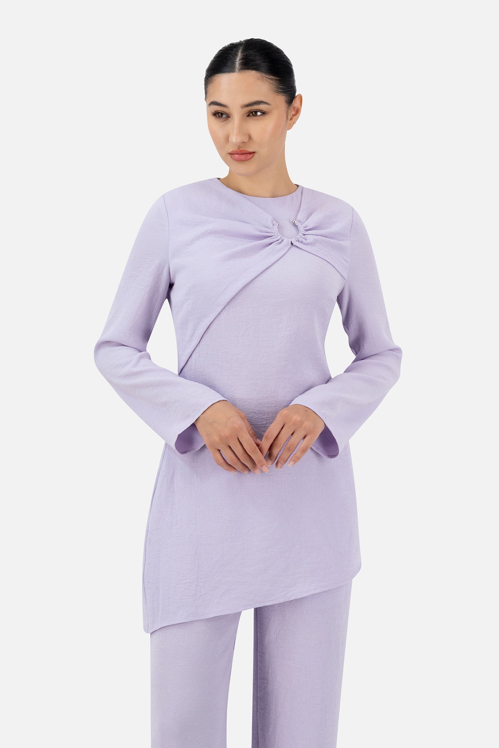Woman wearing the Lilac gathered ring asymmetric tunic, front view with a relaxed and elegant silhouette.