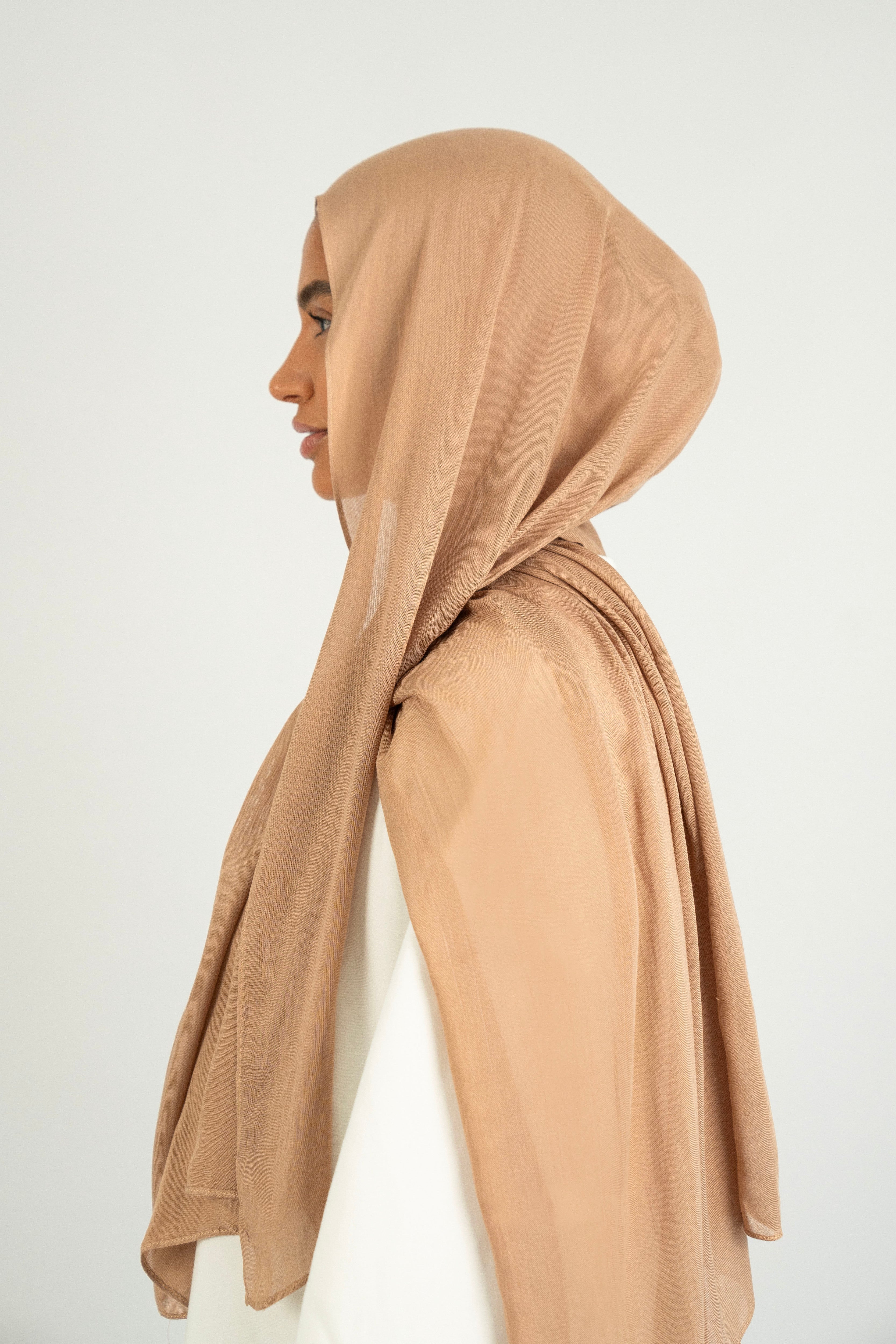 The model is turned left in a Matching Butter Modal Hijab Set. Colour: Almond
