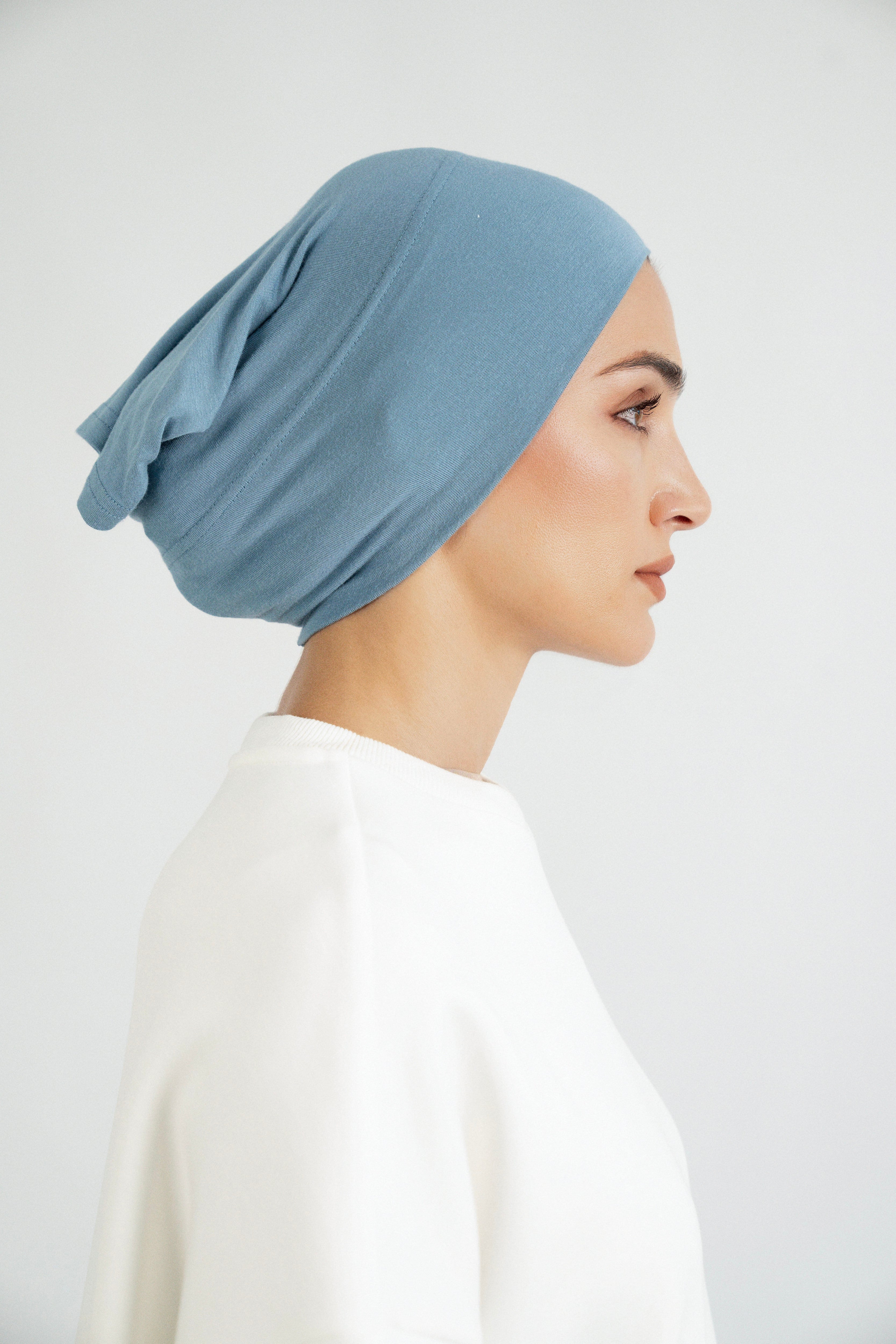 Colour: Marina. The right profile of a girl wearing a modal hijab undercap.