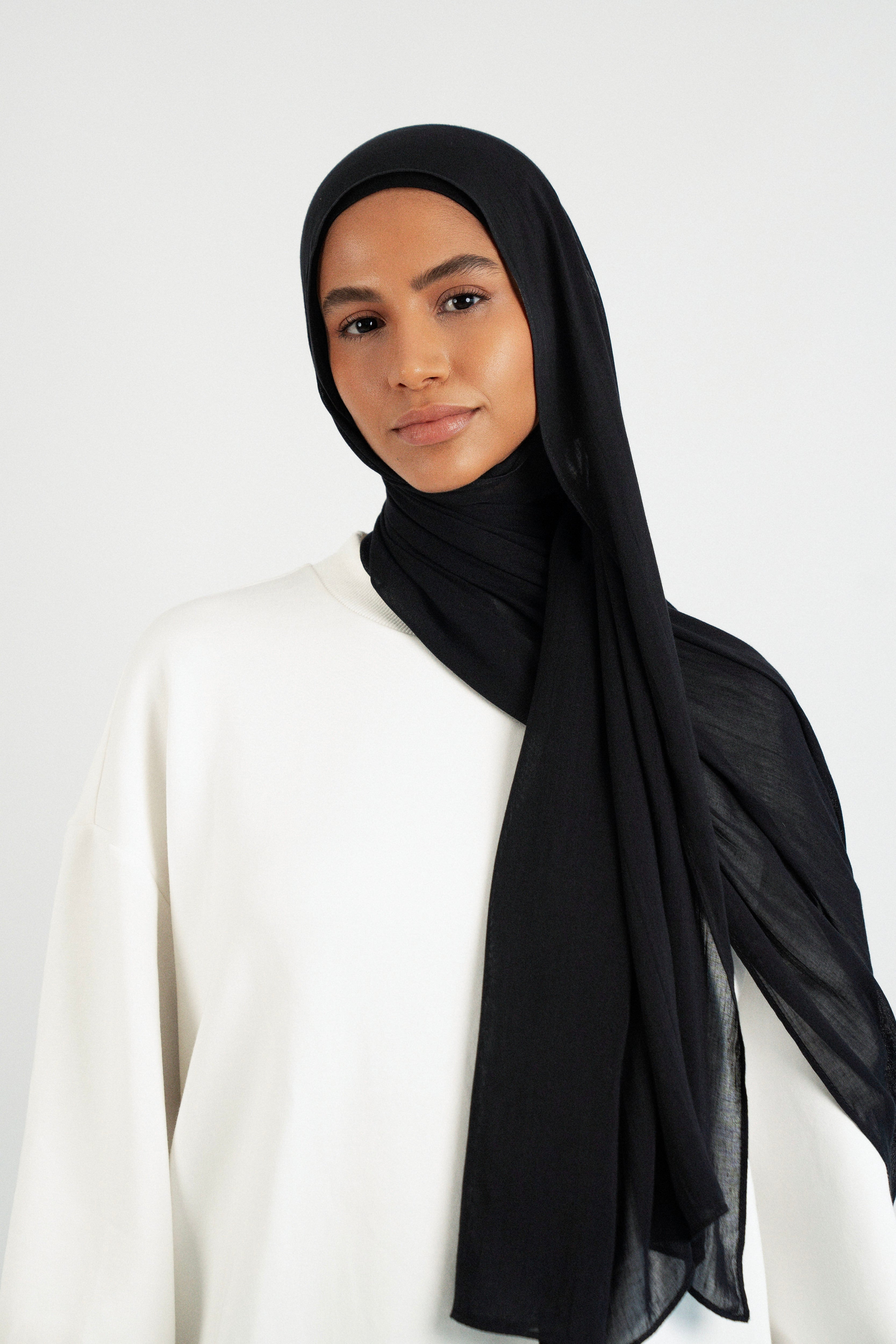Colour: Black. A front pose from a model in a Matching Butter Modal Hijab Set