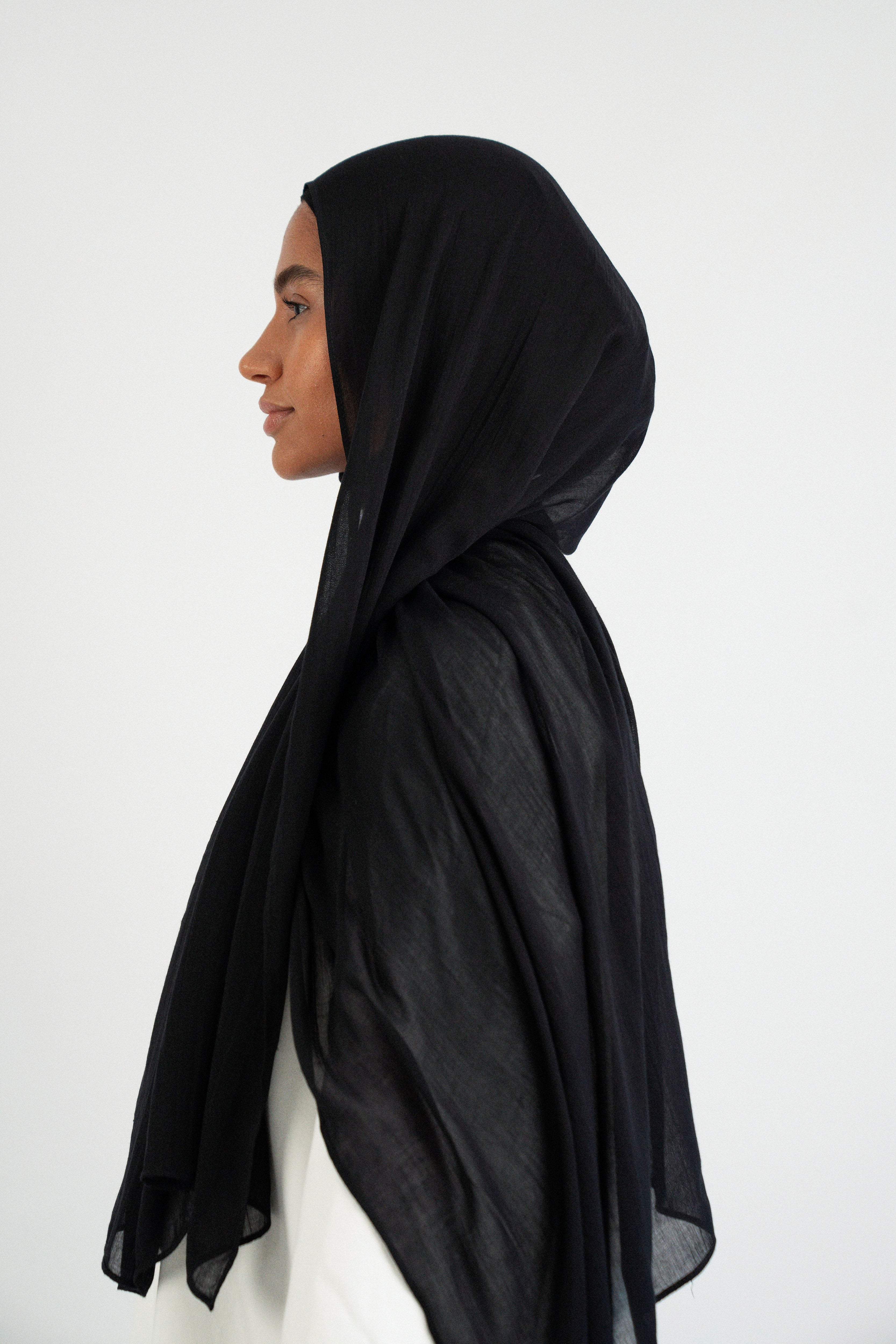 Colour: Black. The girl is turned left in a Matching Butter Modal Hijab Set.