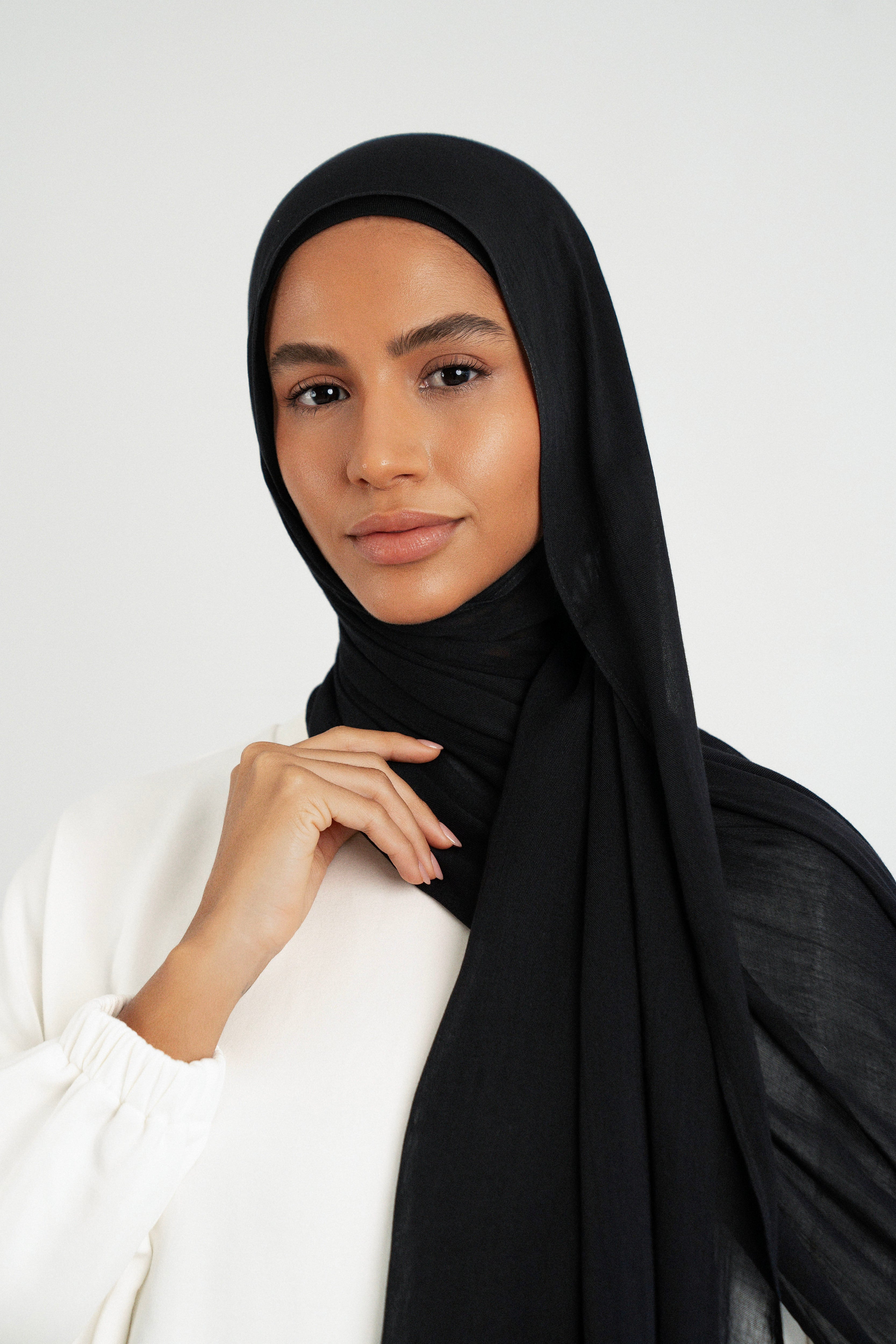Colour: Black. A close up of girl wearing a Matching Butter Modal Hijab Set
