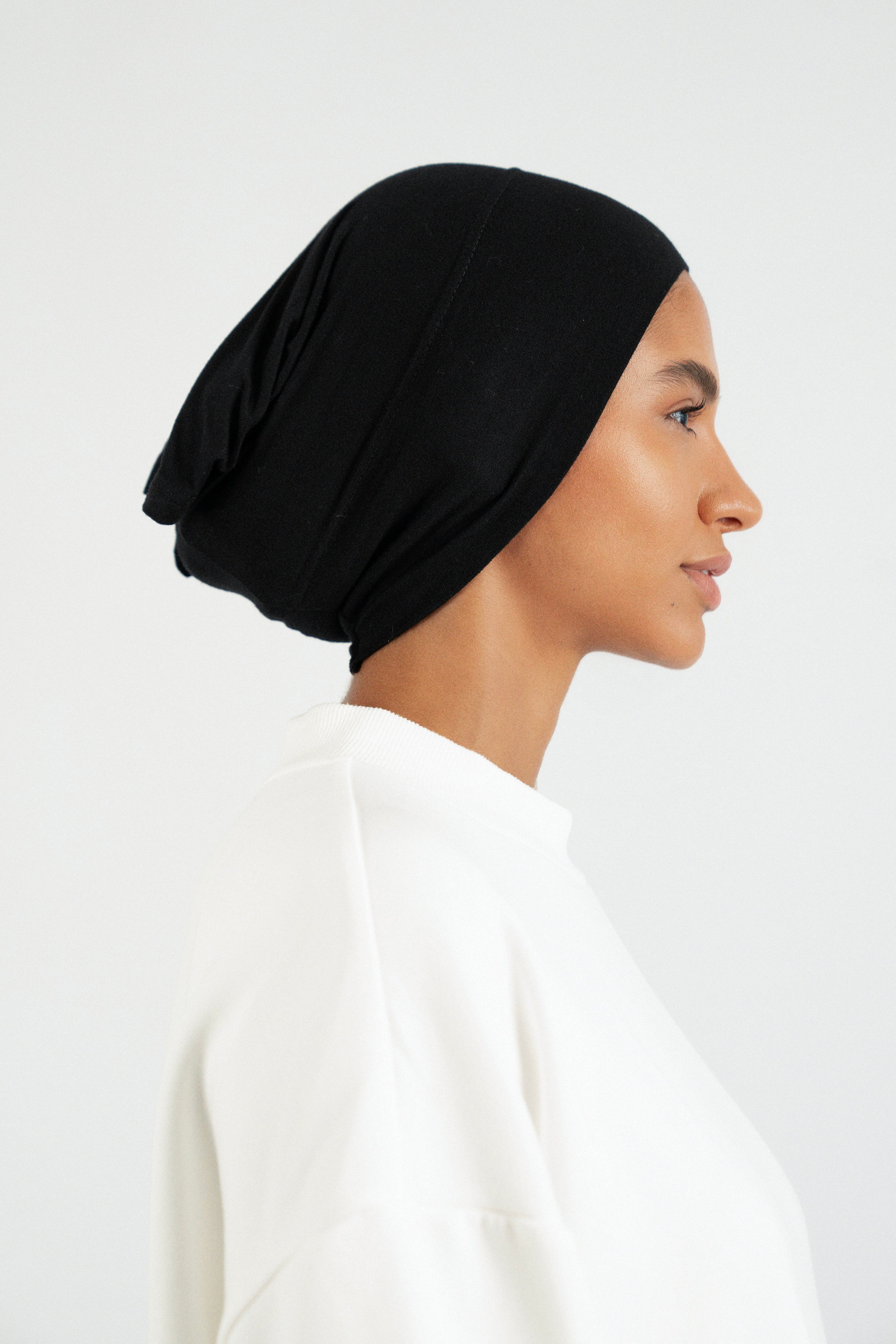 Colour: Black. The right profile of a girl wearing a hijab undercap.
