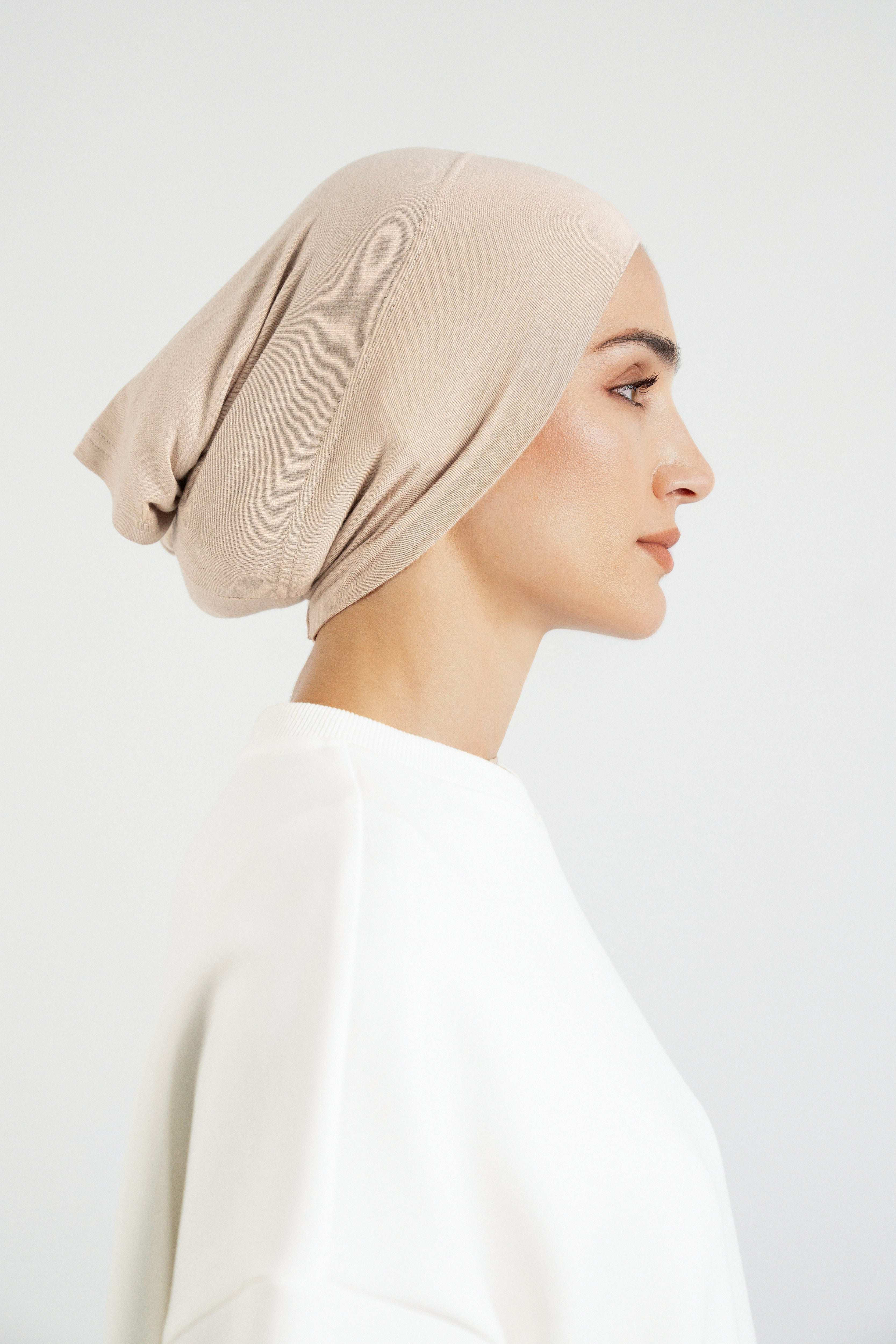 Colour: Biscuit. The right profile of a girl wearing a hijab undercap.