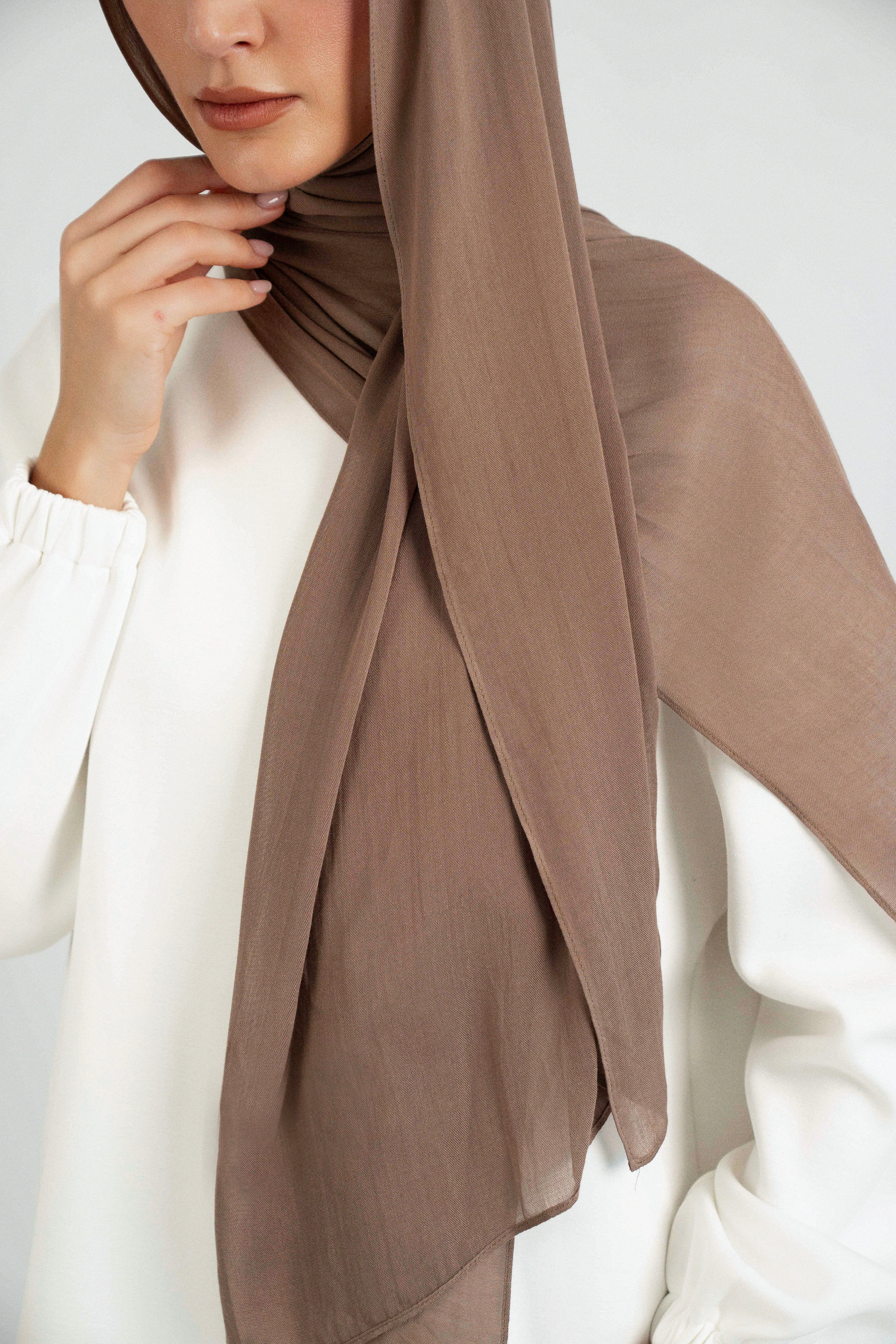 A close up of the Matching Butter Modal Hijab Set fitting on the shoulder of a model. Colour: Walnut.