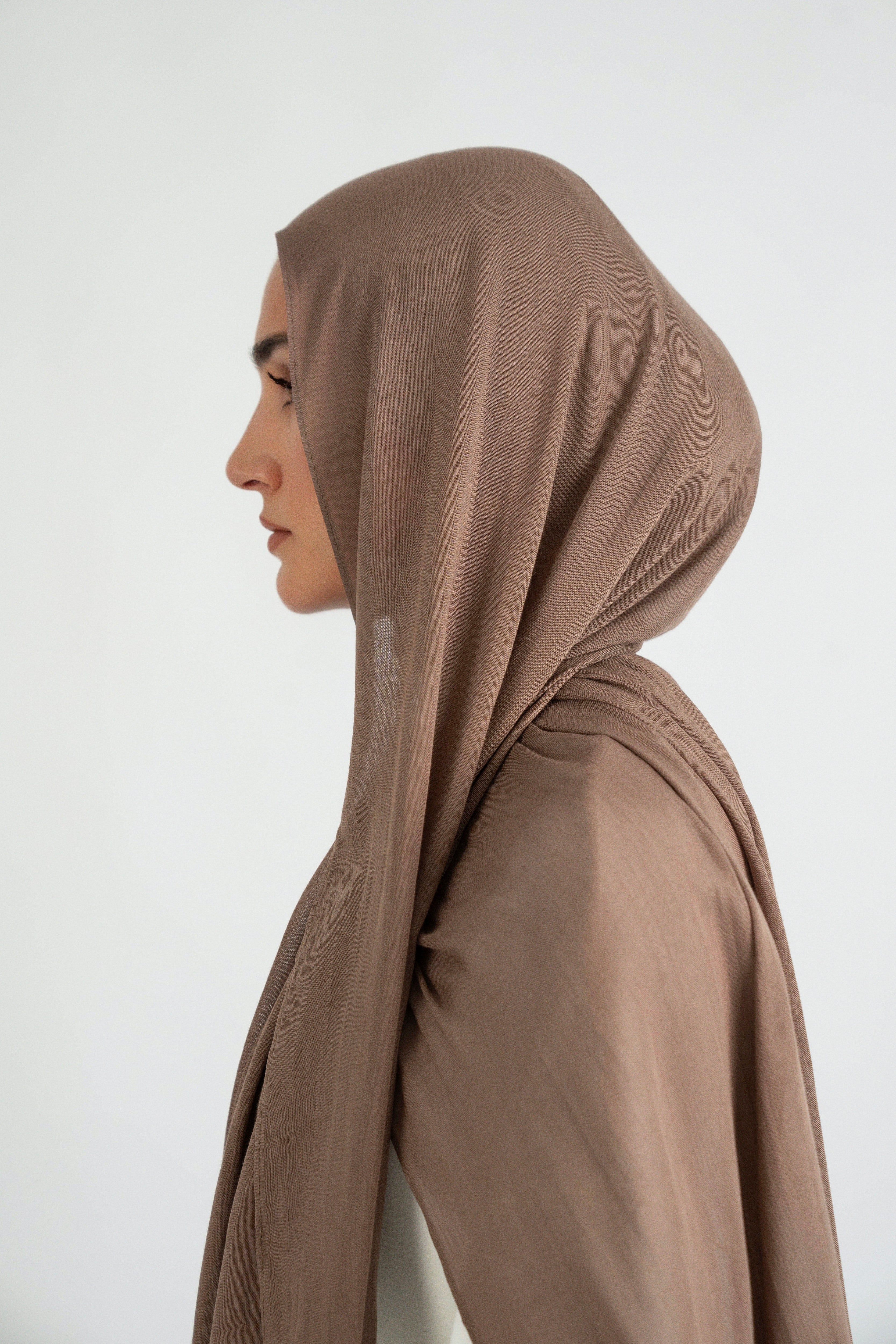 The model is turned left in a Matching Butter Modal Hijab Set. Colour: Walnut.