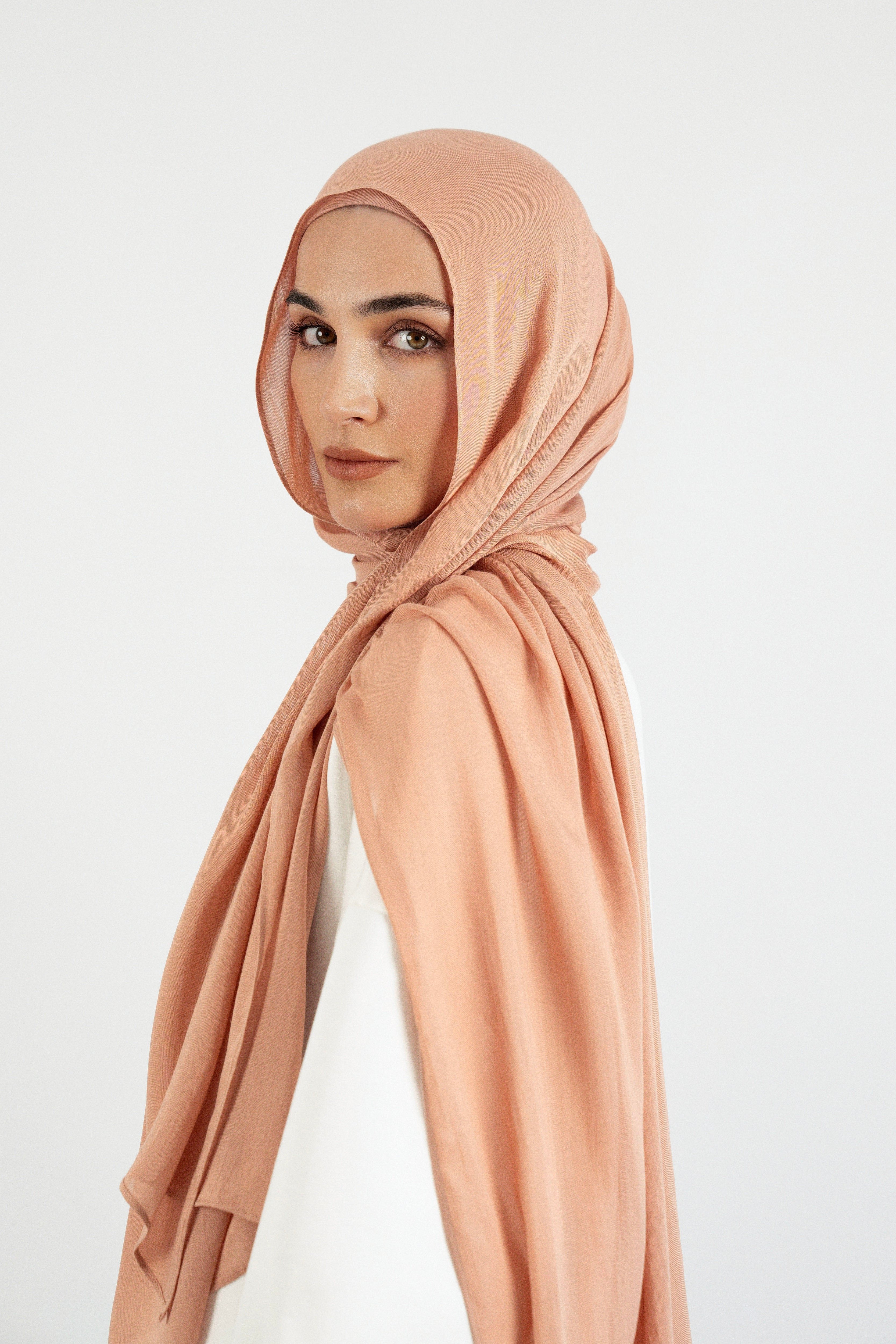 Colour: Clay.  A side pose from a model in a Matching Butter Modal Hijab Set.