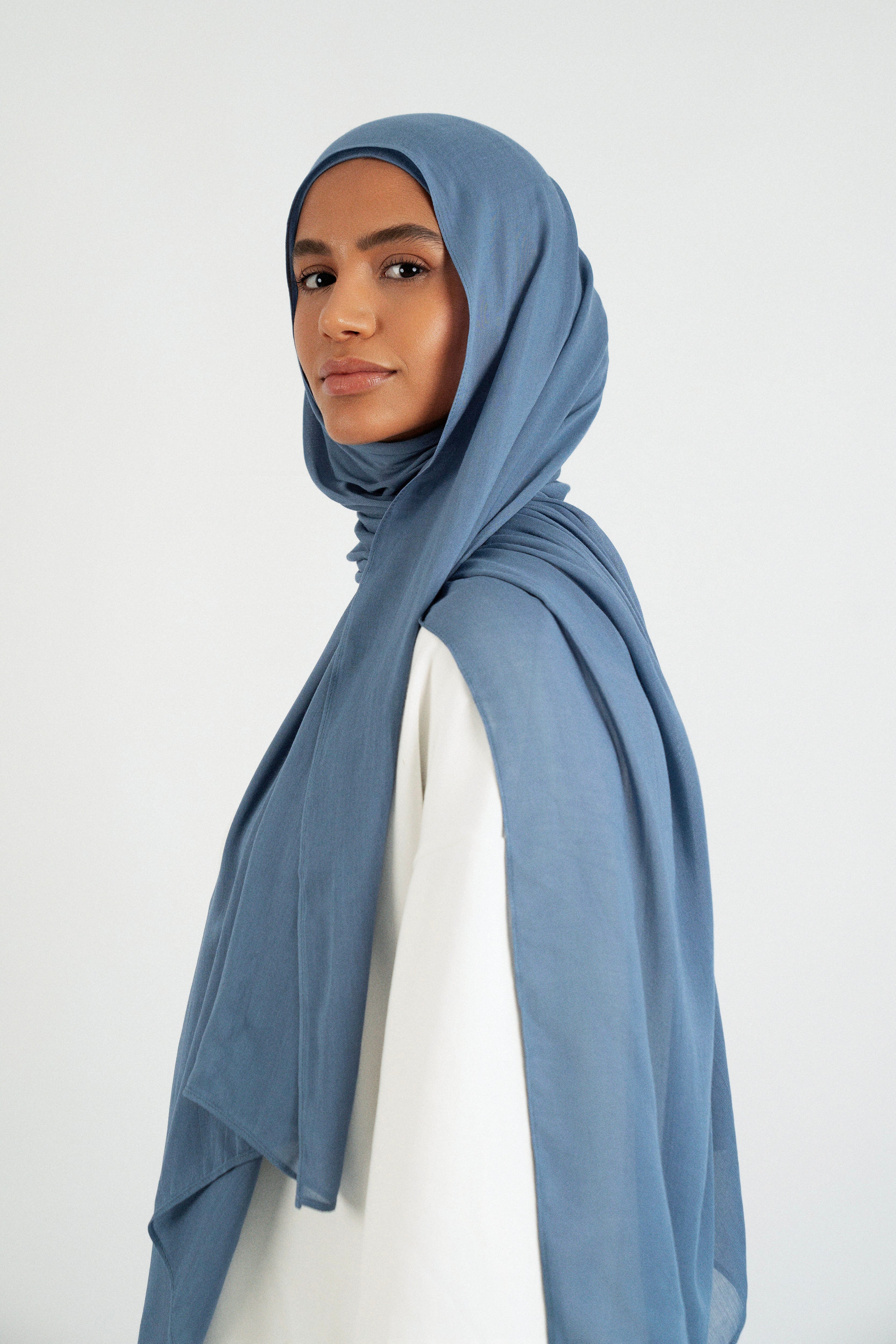Colour: Denim. A side pose from a model in a Matching Butter Modal Hijab Set.