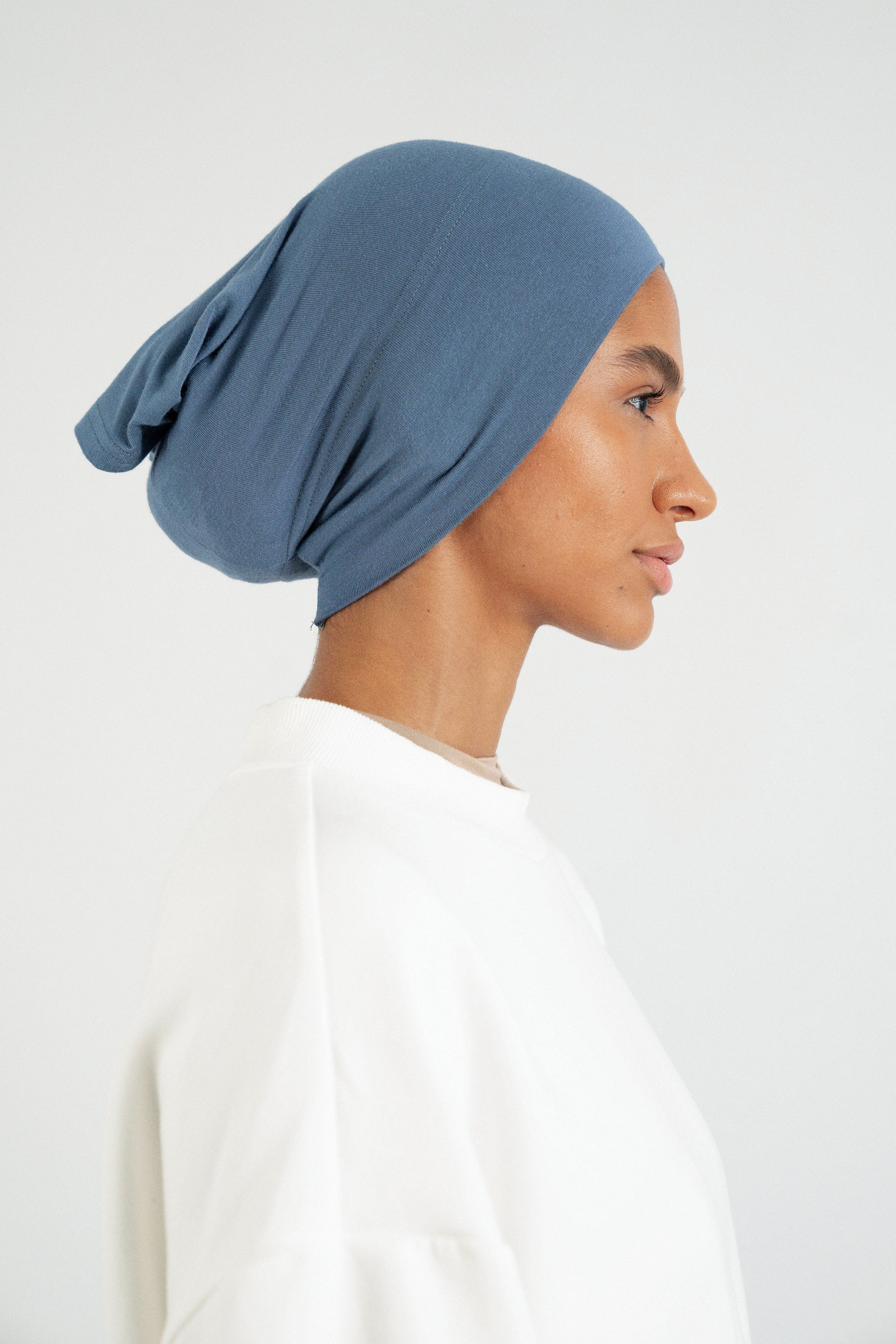 Colour: Denim. The right profile of a girl wearing a modal hijab undercap.