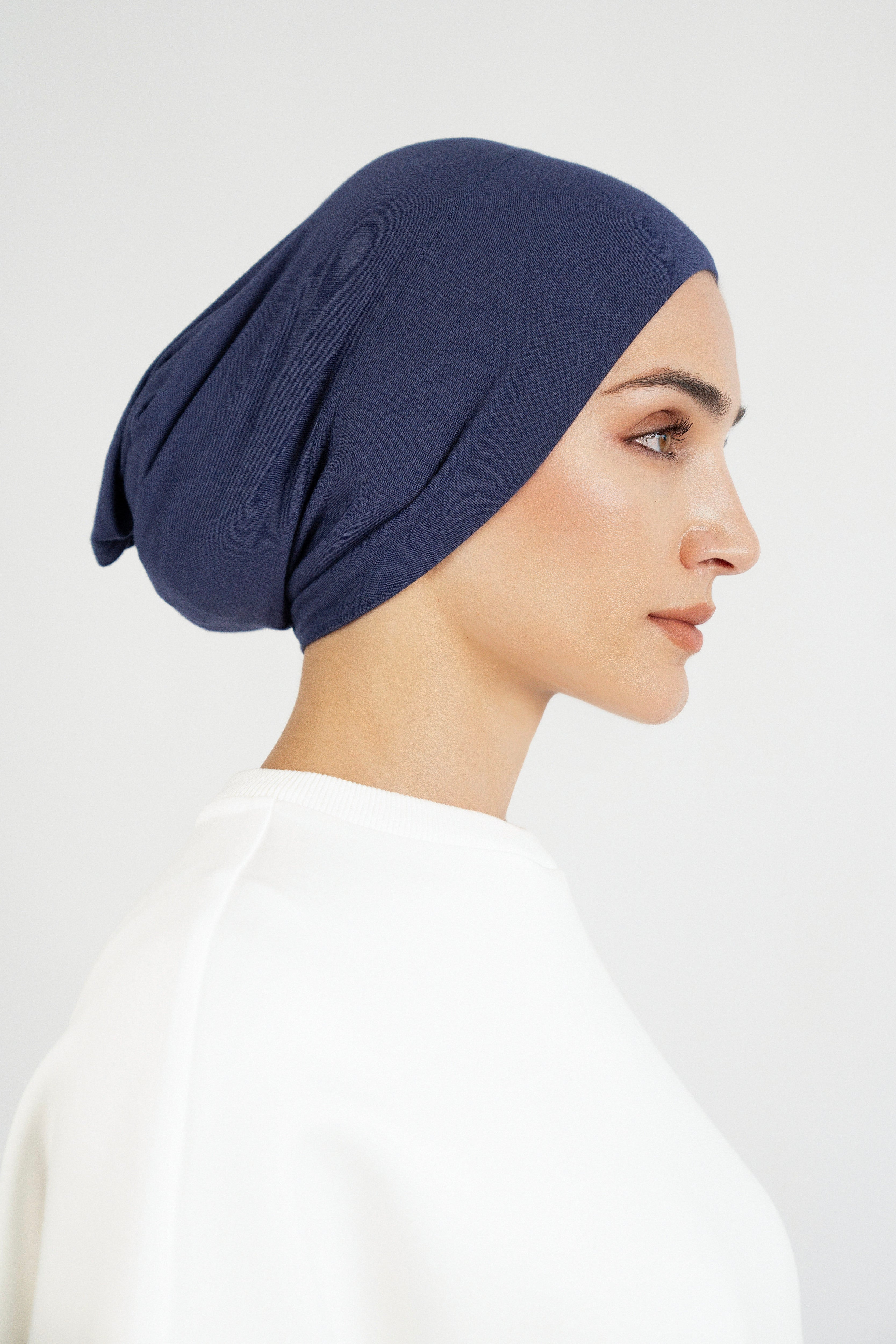 Colour: Navy. The right profile of a girl wearing a modal hijab undercap.