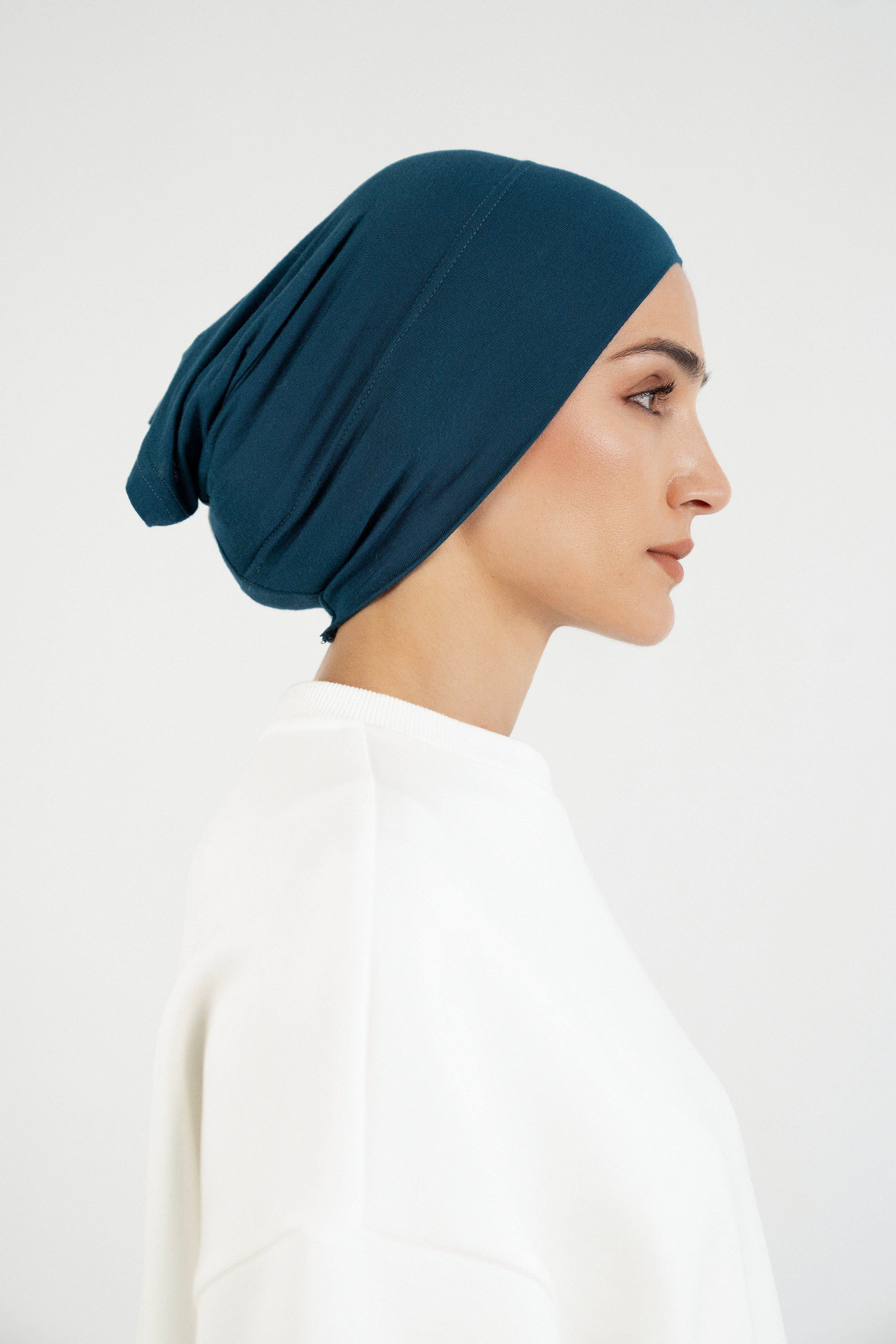 Colour: Real Teal. The right profile of a model wearing a modal hijab undercap.
