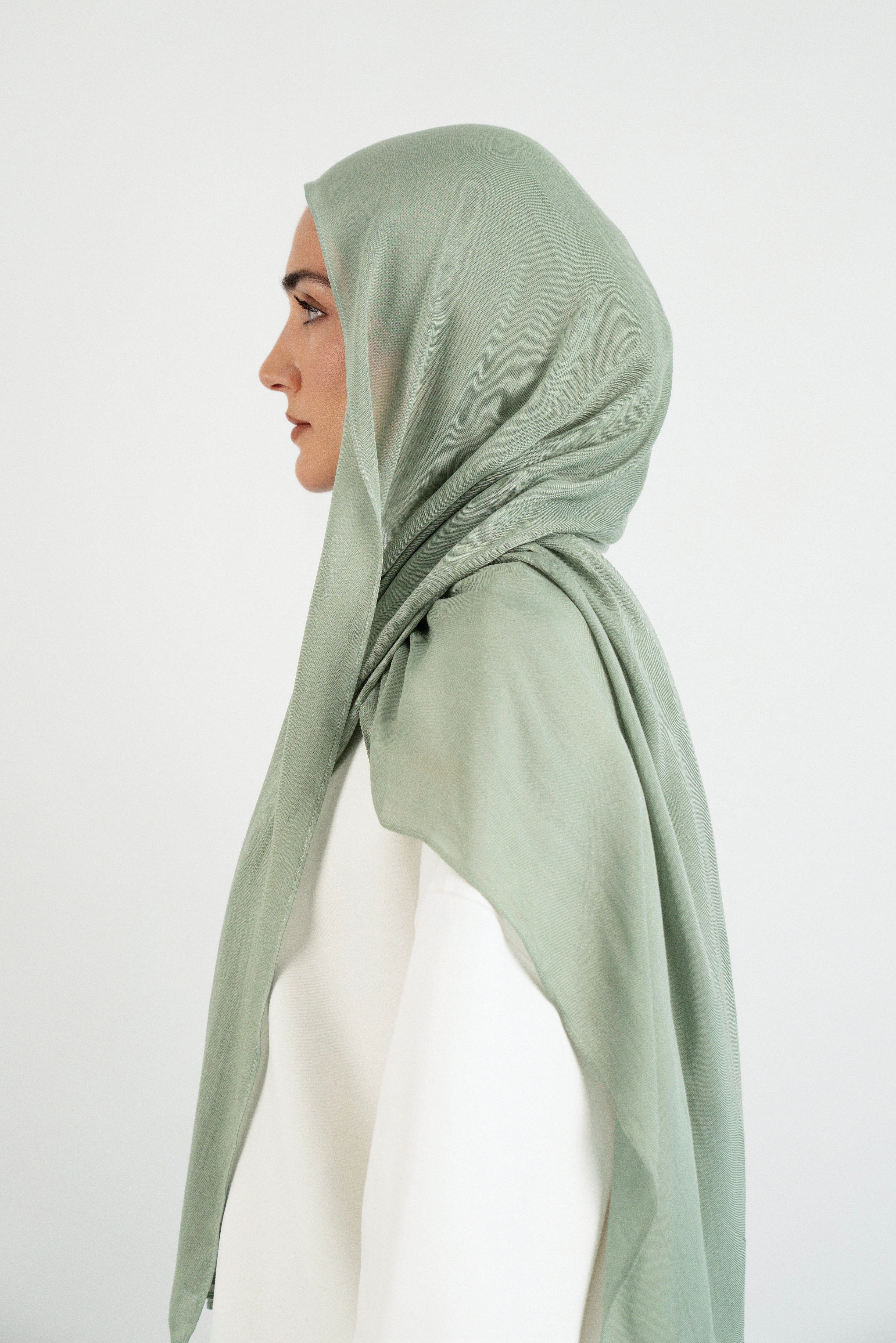 Colour: Sage. A woman is turned left in a Matching Butter Modal Hijab Set.