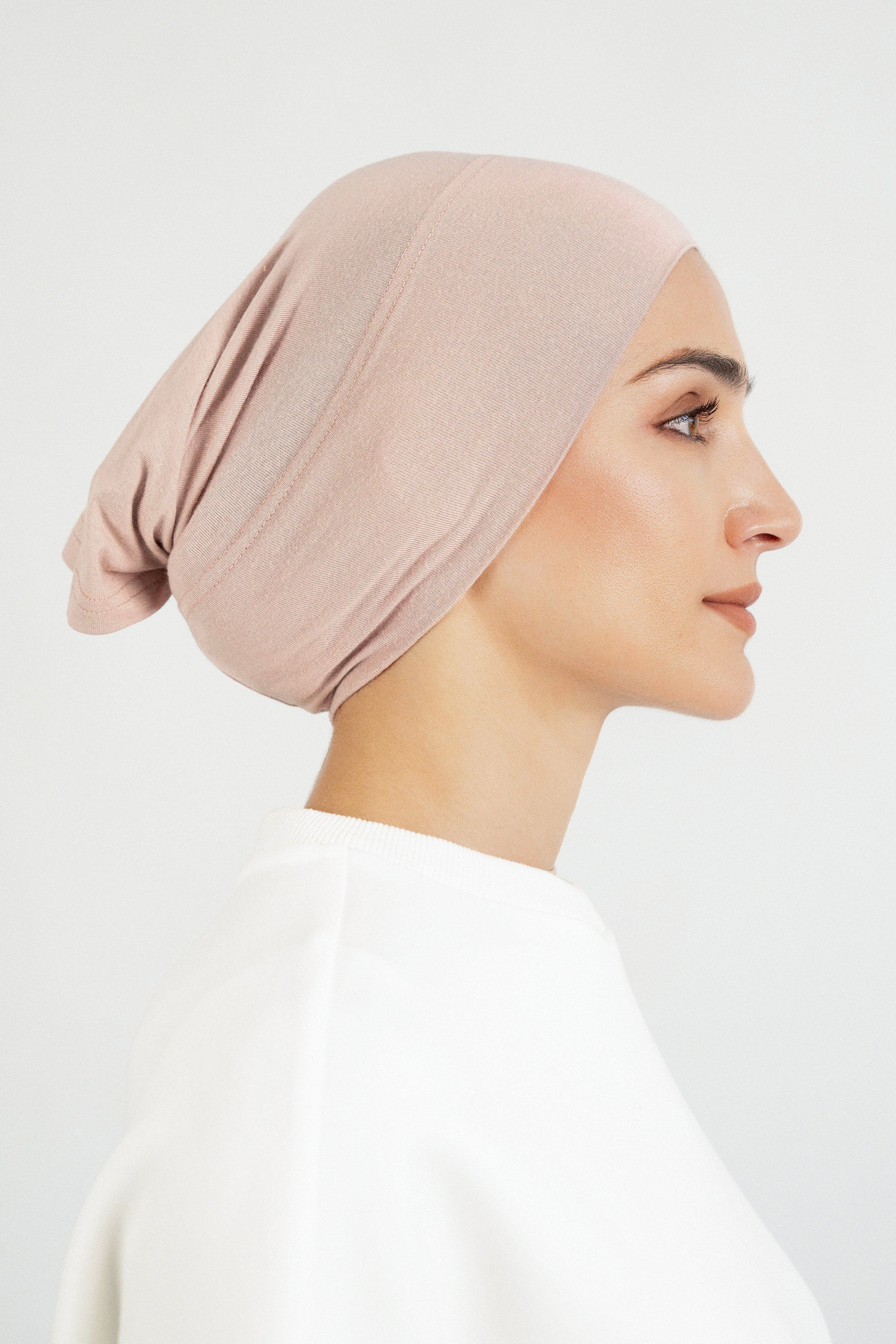 Colour: Seashell. The right profile of a model wearing a modal hijab undercap.