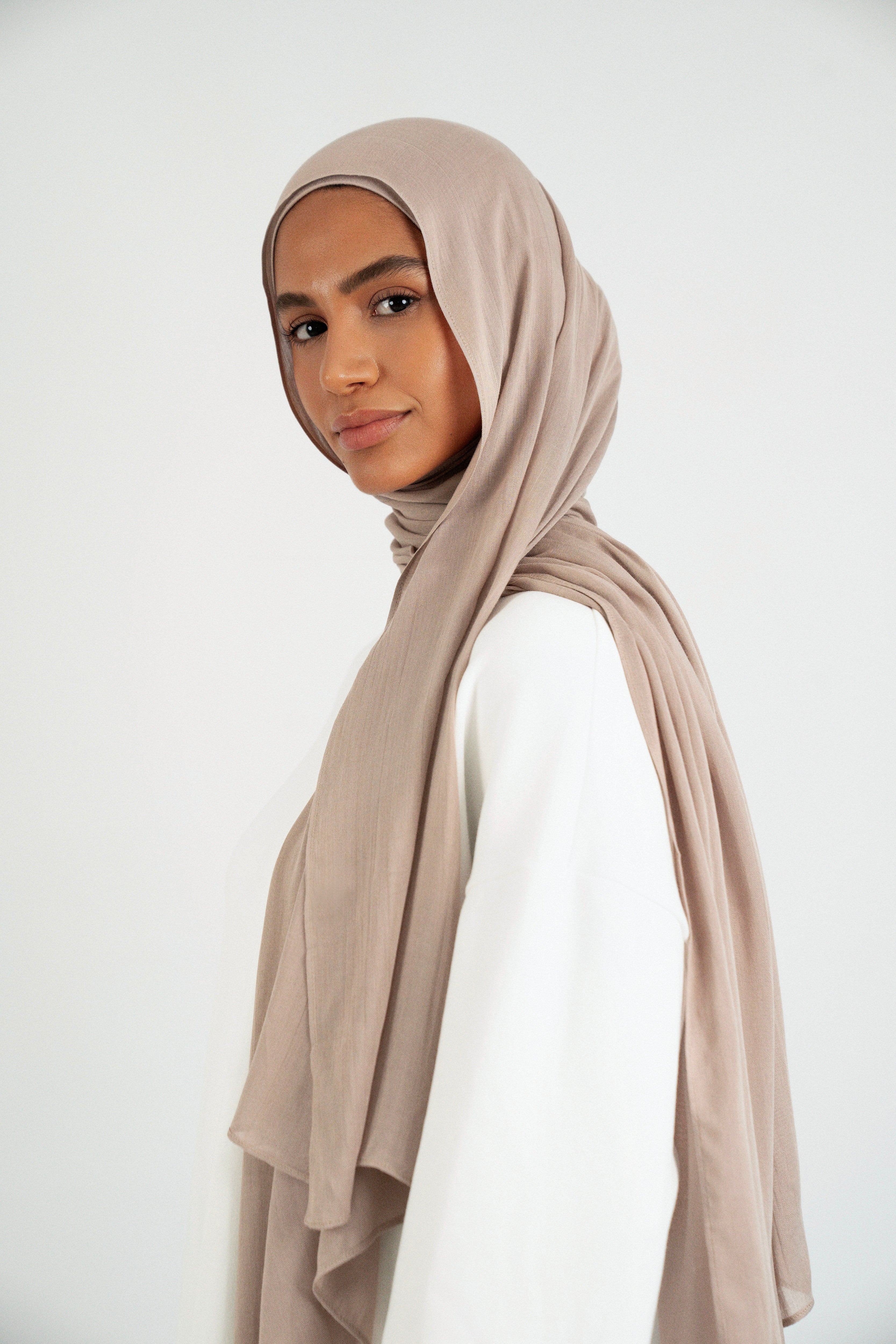The model is turned left in a Matching Butter Modal Hijab Set. Colour: Almond