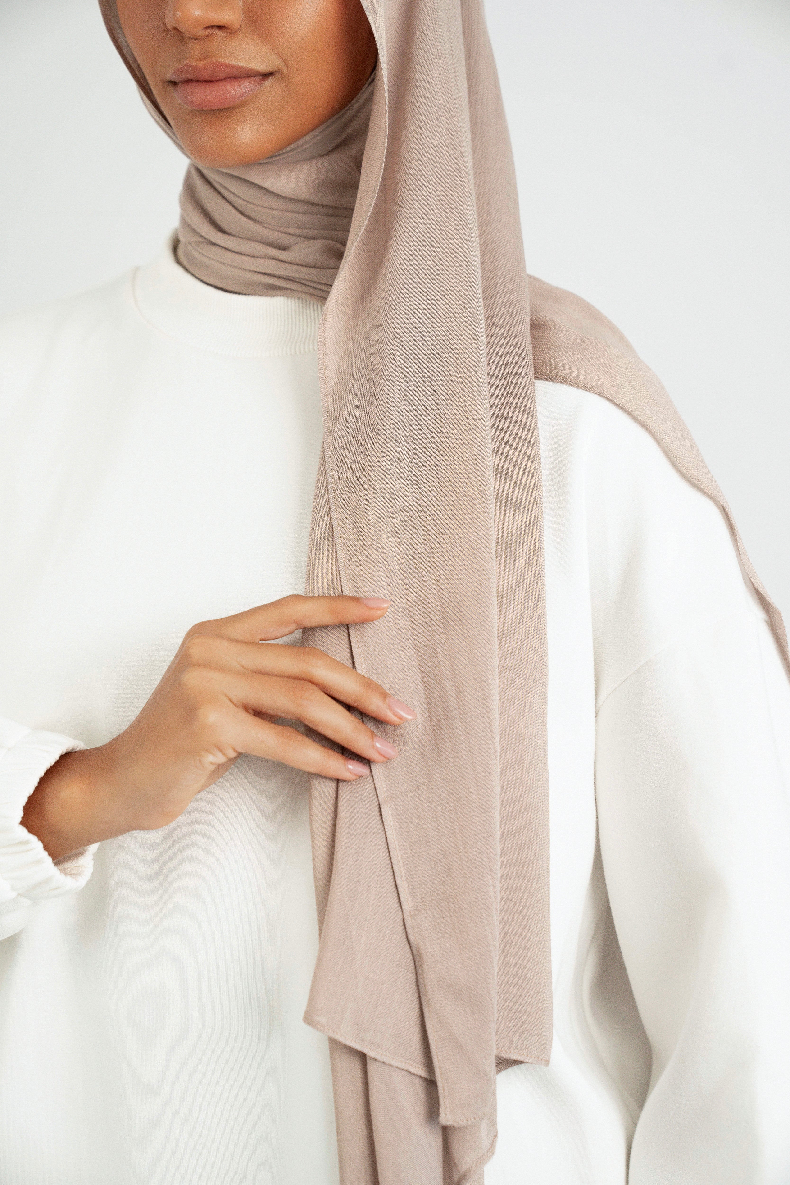 A close up of the Matching Butter Modal Hijab Set fitting on the shoulder of a model. Colour: Sesame.