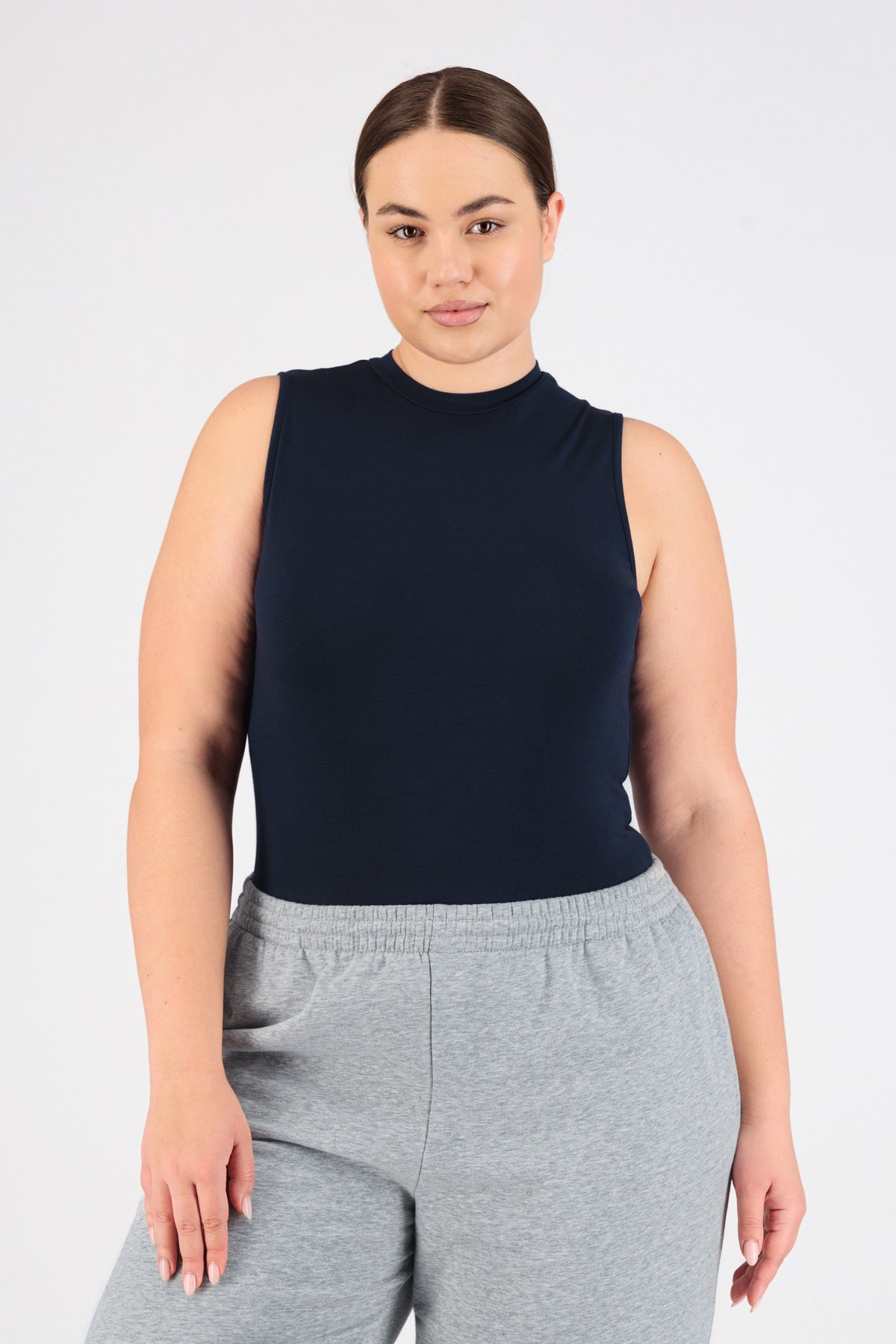 The front of a model standing in FARES' sleeveless layer. Colour description: Navy.