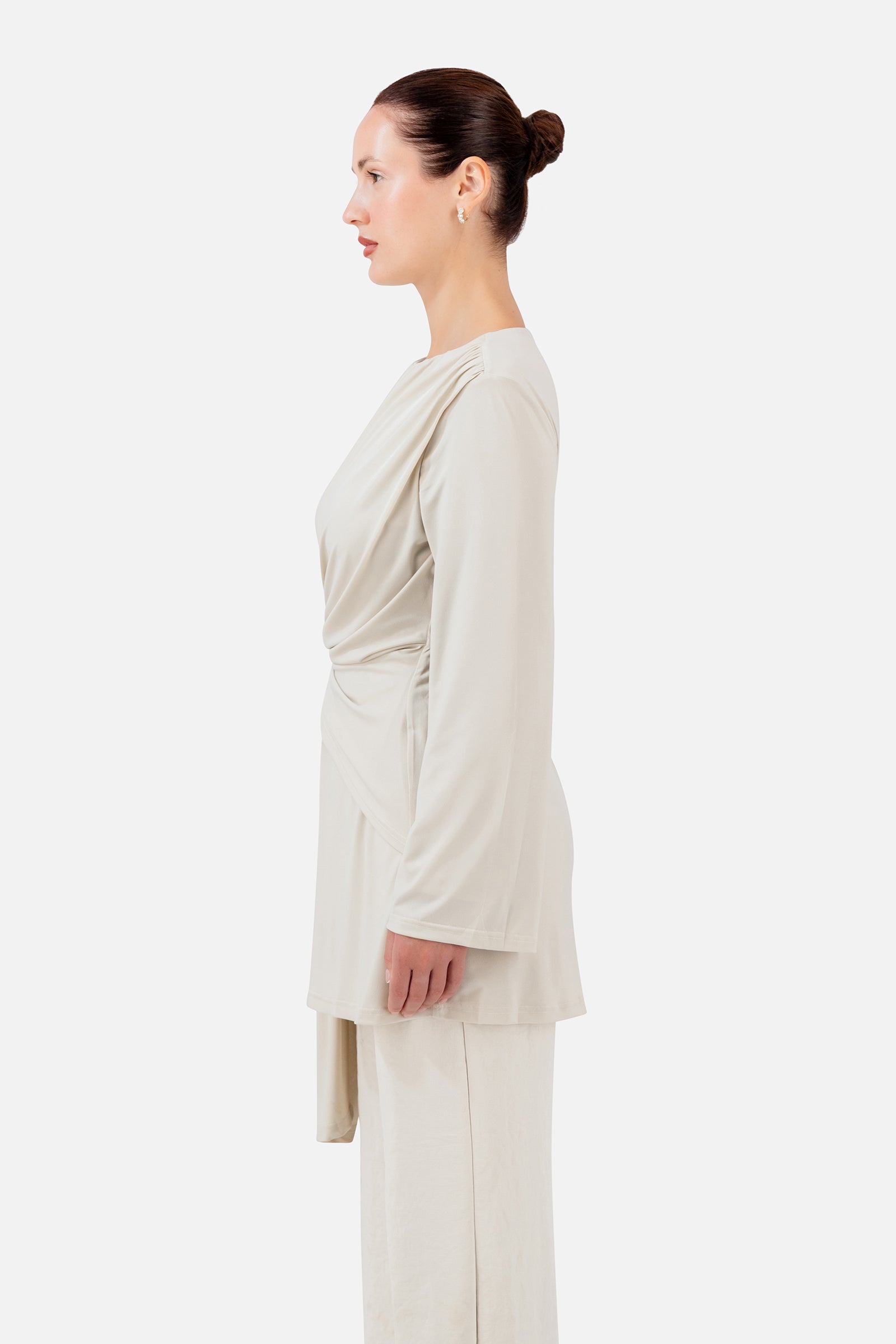 FARES Side Draped Tunic in Vanilla Cream shown from the side, featuring the layered drape and asymmetric length of this tunic.