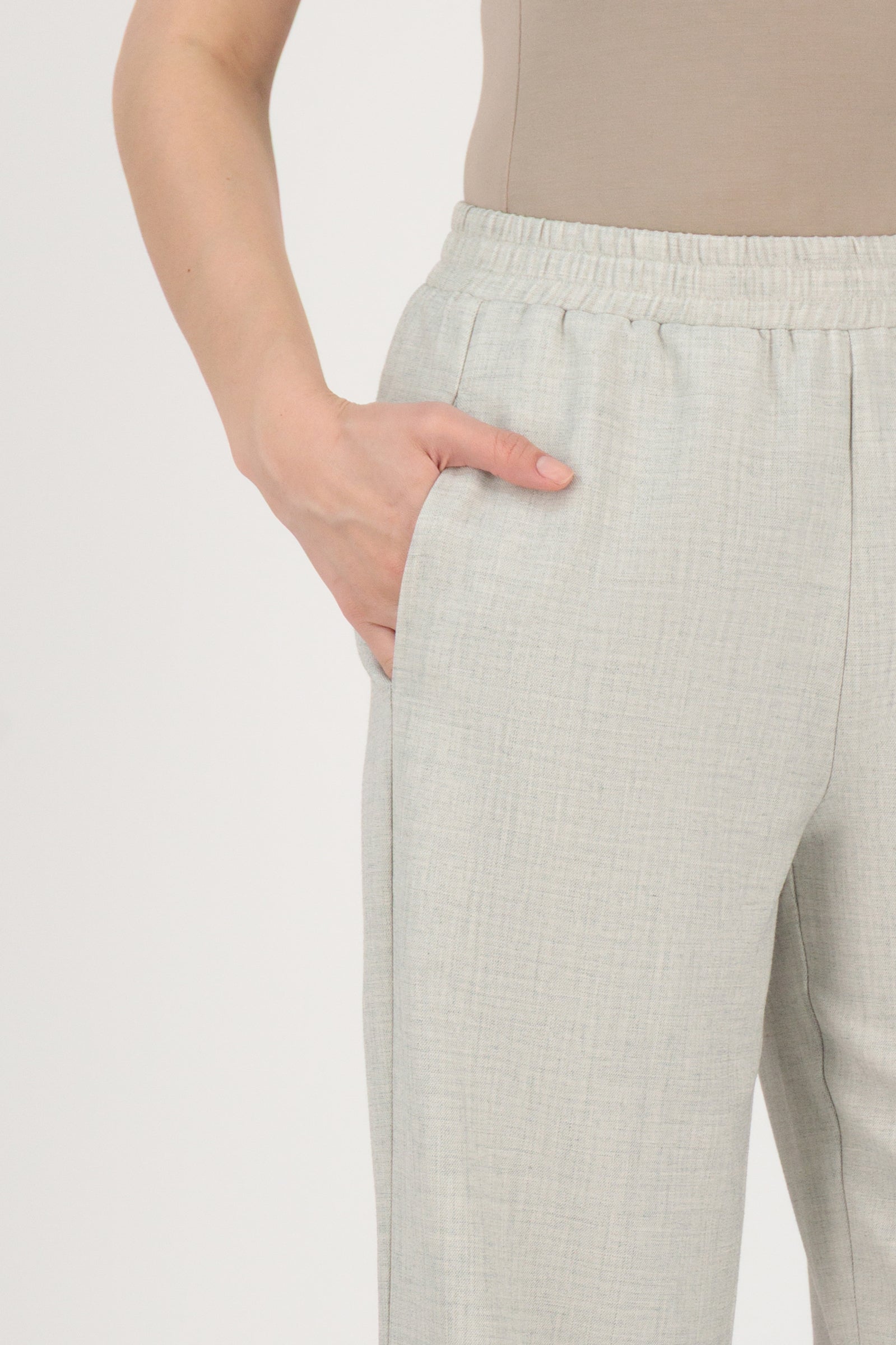 Close-up detail of the FARES Tailored Elastic Waist Pants in Chalk focusing on the elastic waistband and pocket finish of these elastic waist pants.