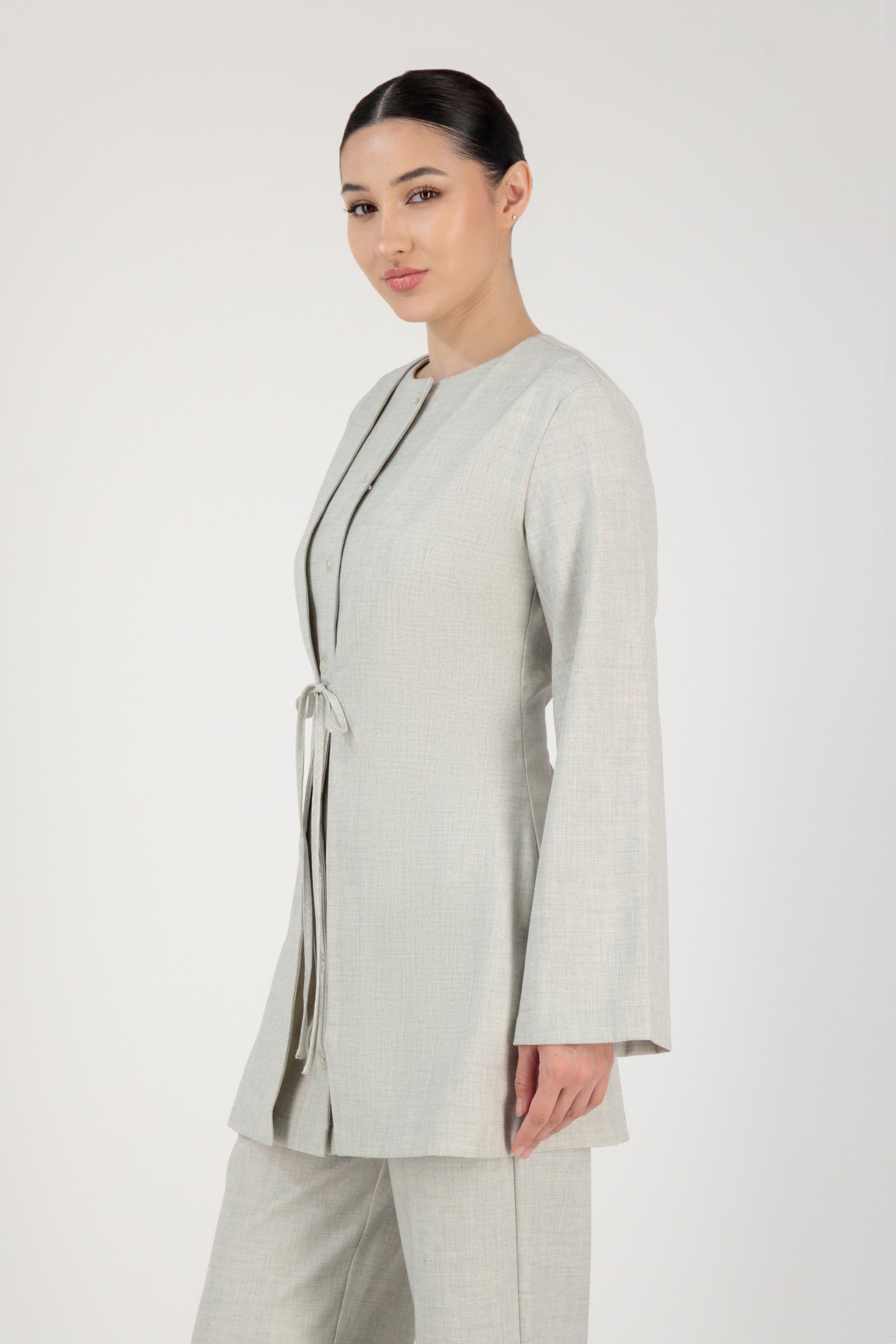 Side angle of the FARES Tailored Button-Up Tunic in Chalk presenting a timeless tunic shape defined by a crisp button-up front.