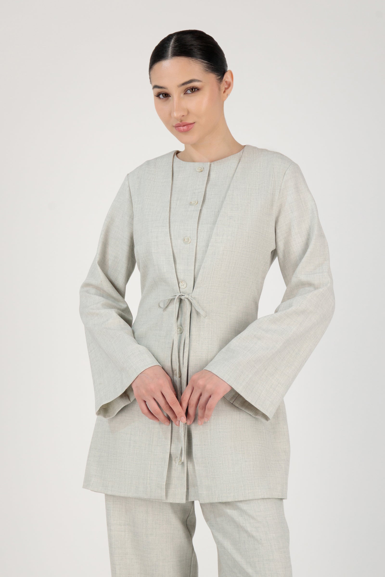 The FARES Tailored Button-Up Tunic in Chalk styled closed, showing how this button-up tunic maintains structure while remaining effortless.
