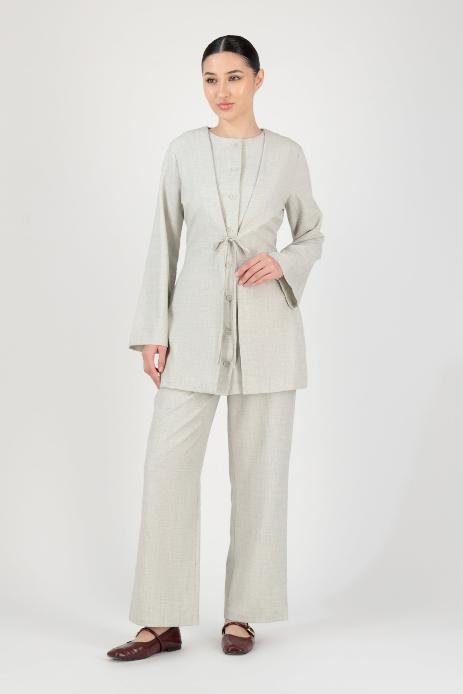 Full-length view of the FARES Tailored Button-Up Tunic in Chalk worn as polished tunic clothing paired with matching trousers.