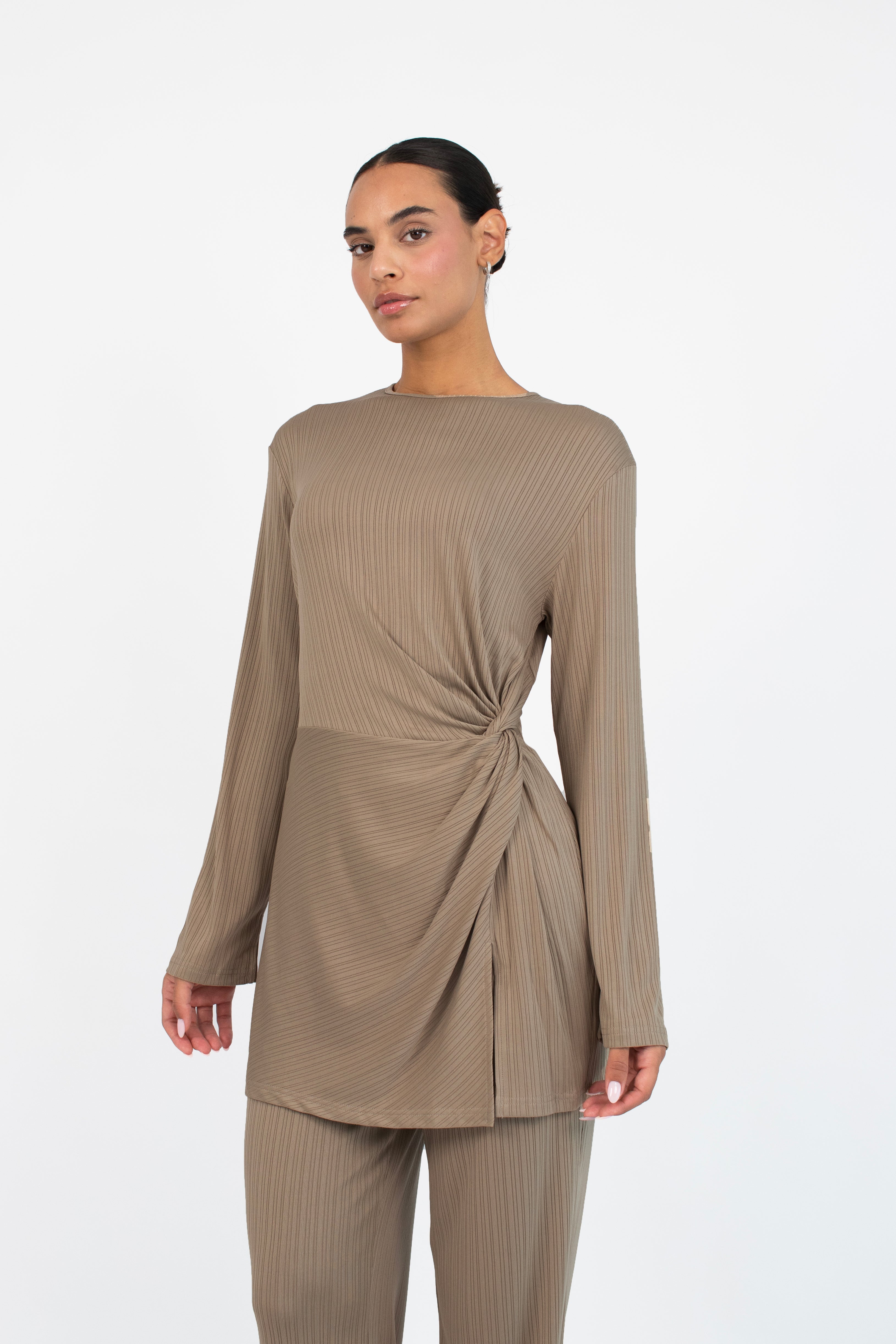 Colour: Taupe. A closer look of a girl in a front pose wearing a Ribbed Side Twist Top.