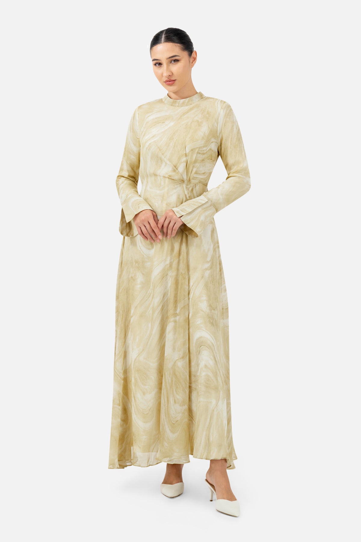 Woman standing in the Printed Watercolour Dress with long sleeves and a flattering silhouette.