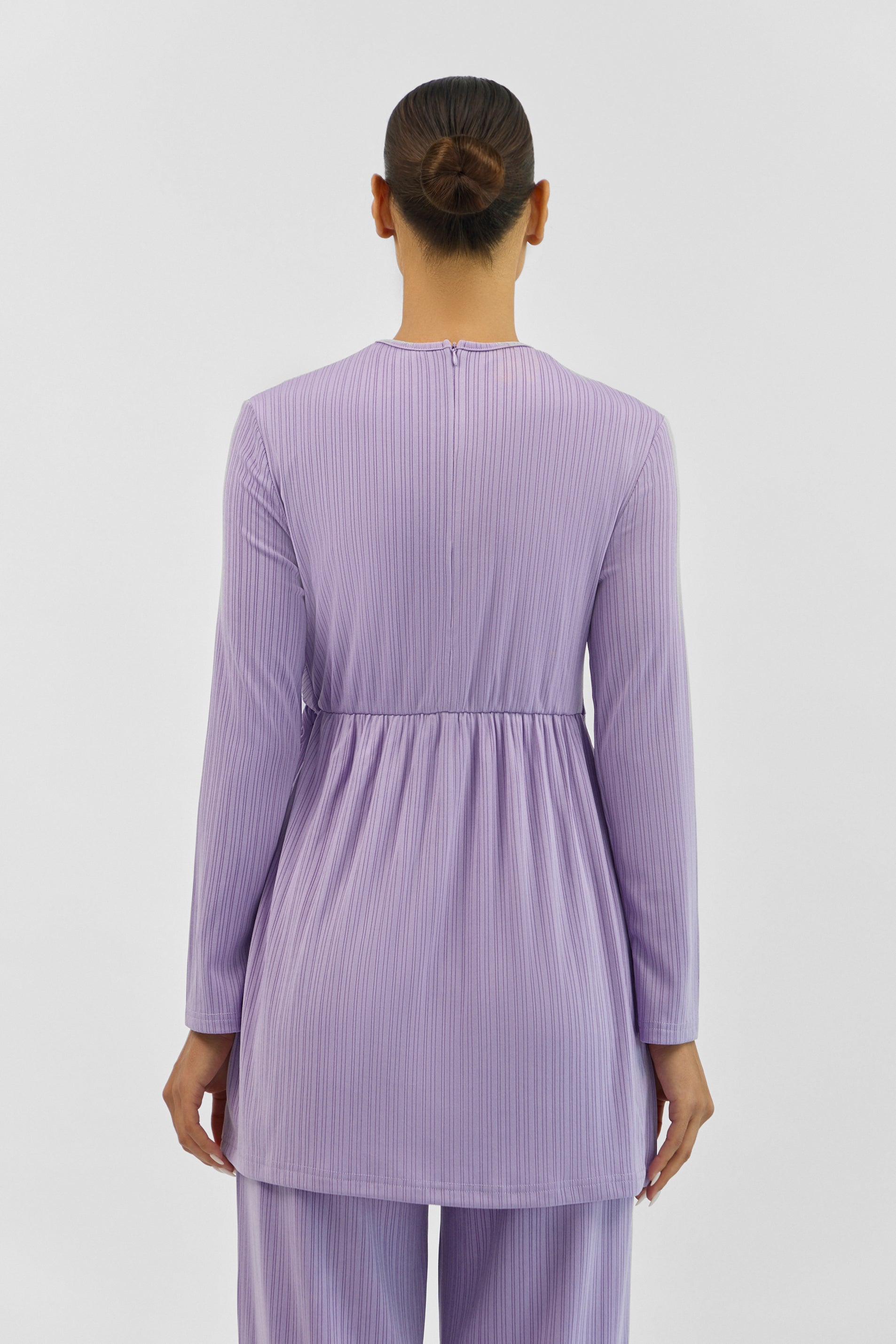 Back view of the FARES Ribbed Side Twist Top in Purple, highlighting the smooth fit and clean lines of the ribbed top.