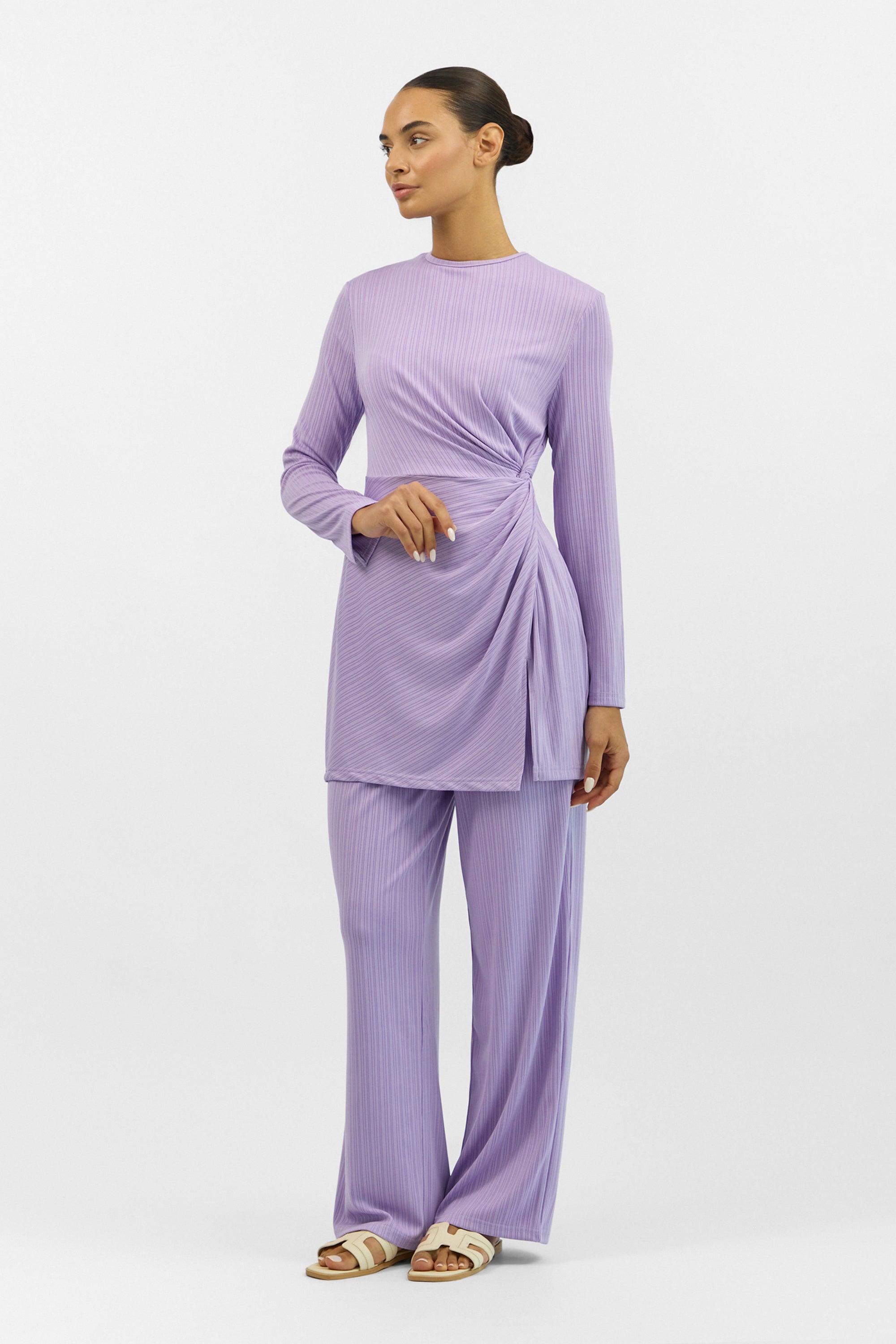 Model wearing the FARES Ribbed Side Twist Top in Purple, styled with matching bottoms to show the versatility of the ribbed top.