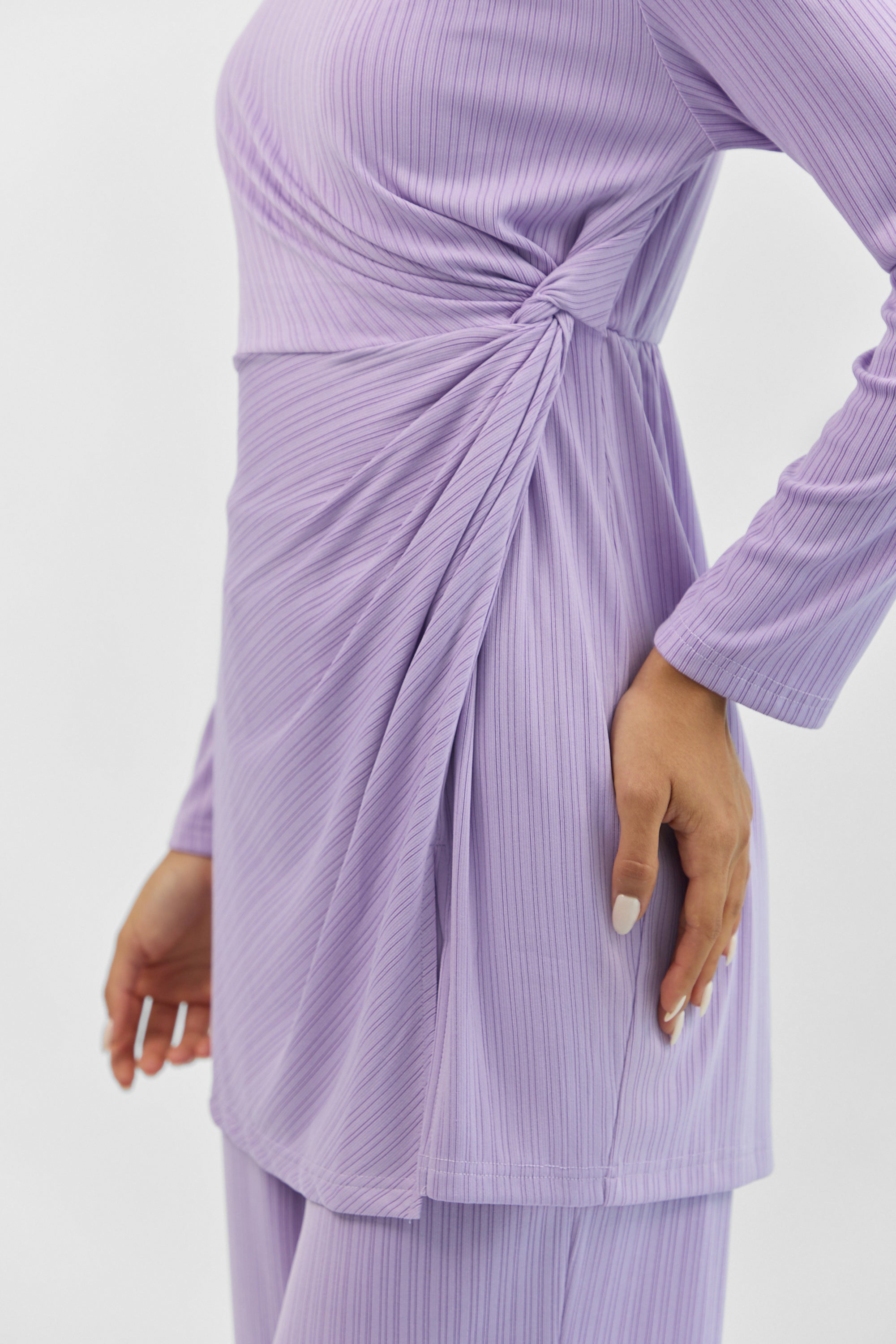 Detail of the ribbed texture and twist accent on the FARES Ribbed Side Twist Top in Purple.
