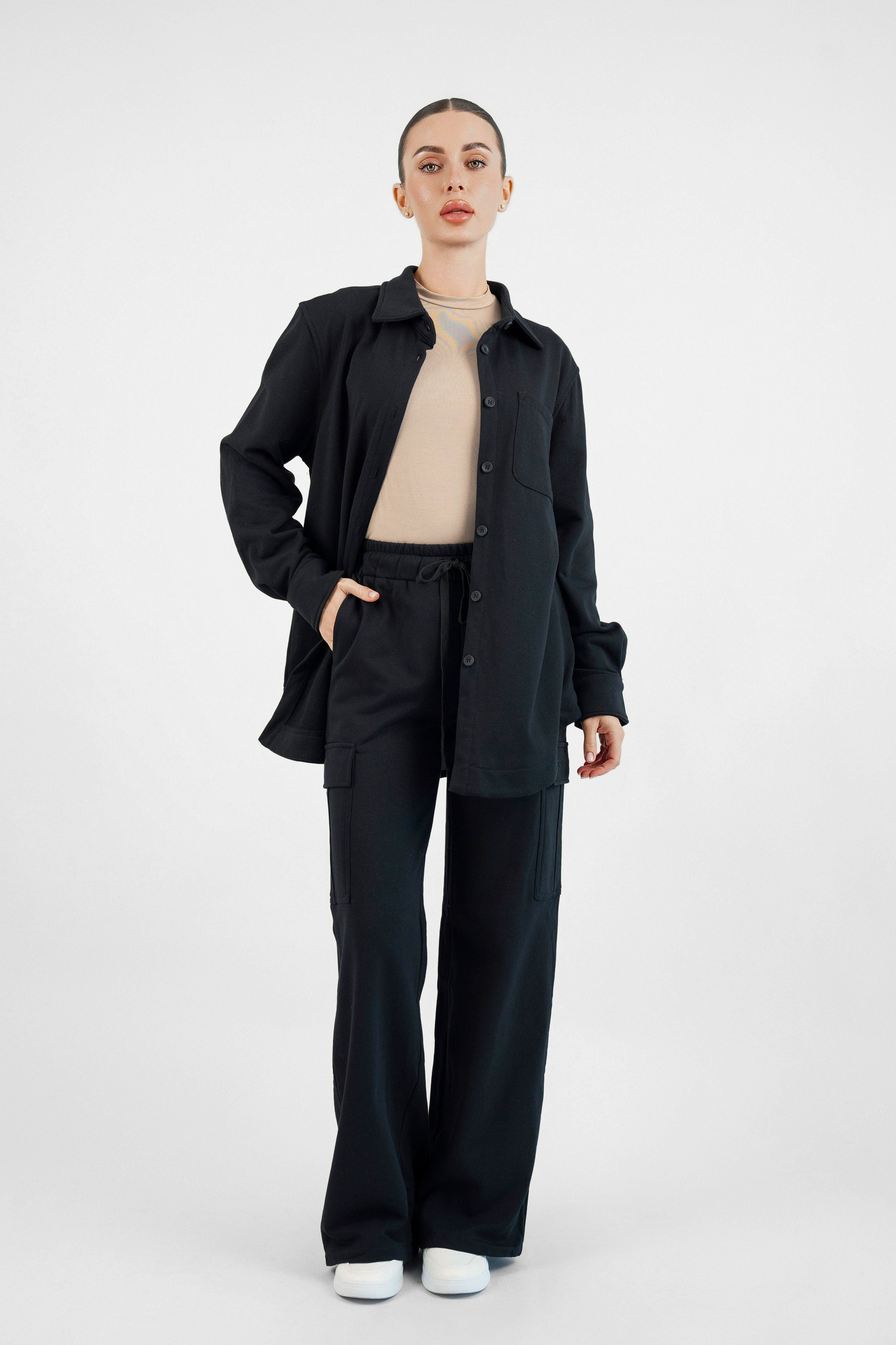Colour: Black A model front posing with her hand in her pocket wearing an Oversized Cotton Shacket.