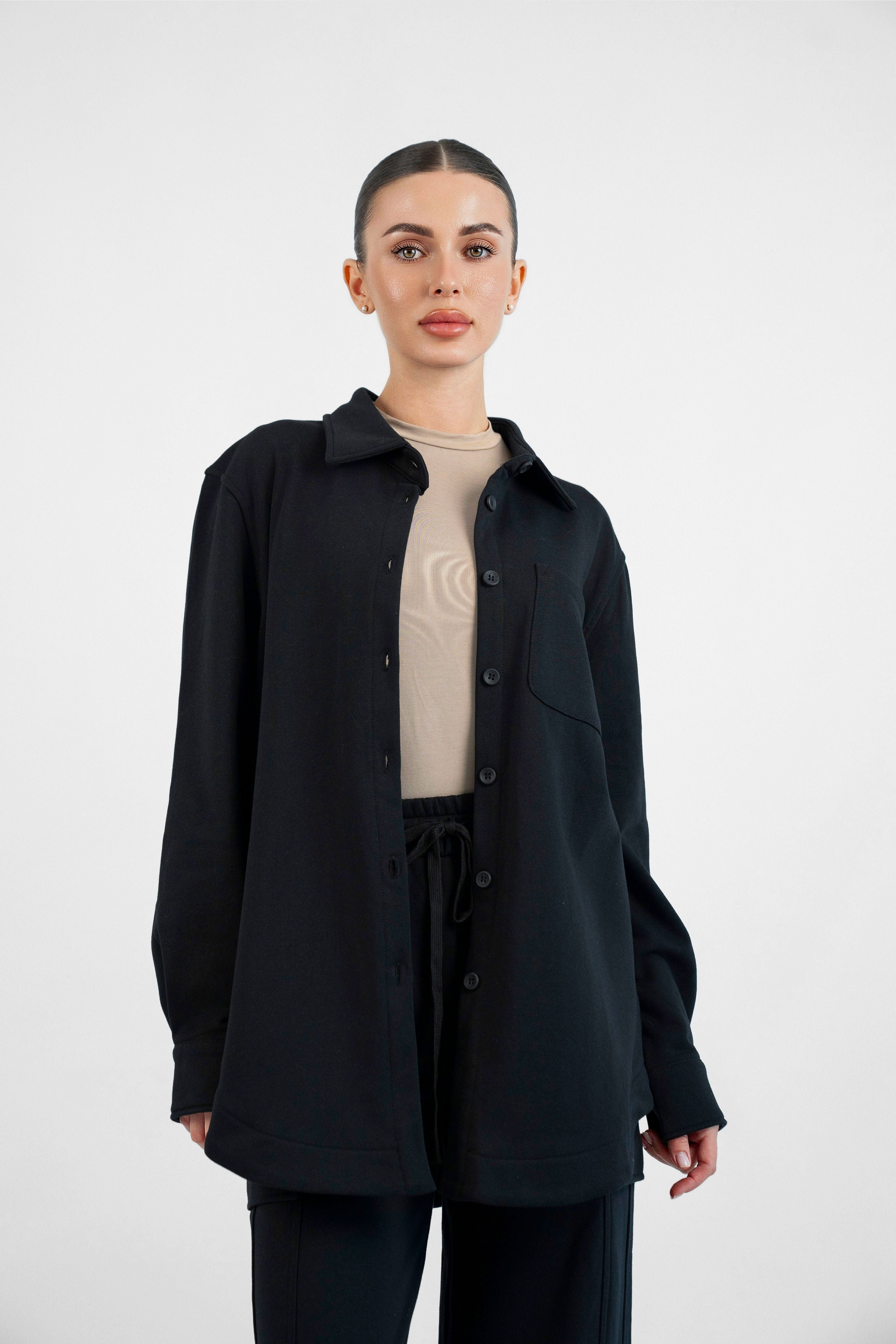 Colour: Black. A model in a front pose wearing an Oversized Cotton Shacket.