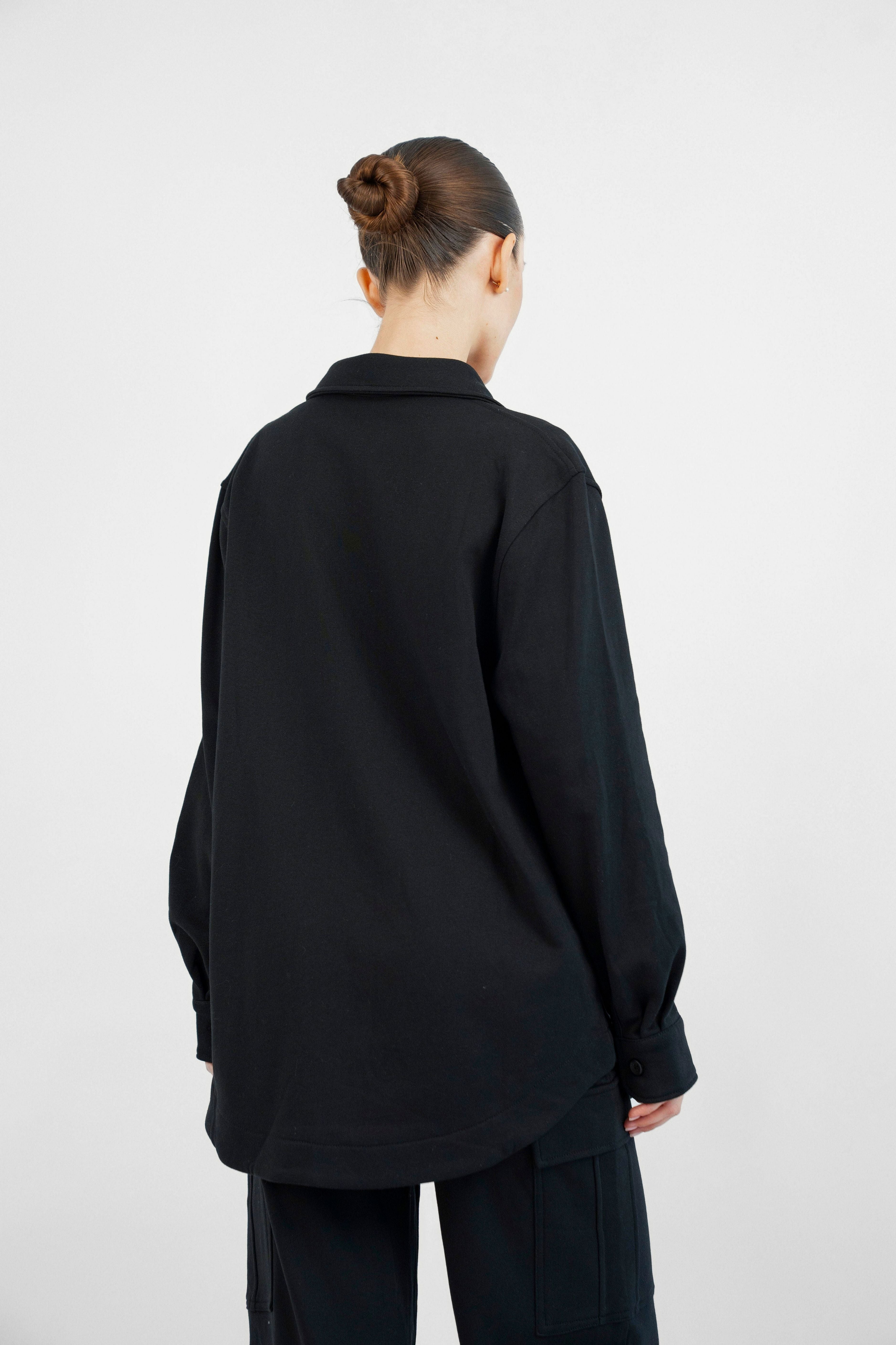 Colour: Black. The back of a woman wearing an Oversized Cotton Shacket.