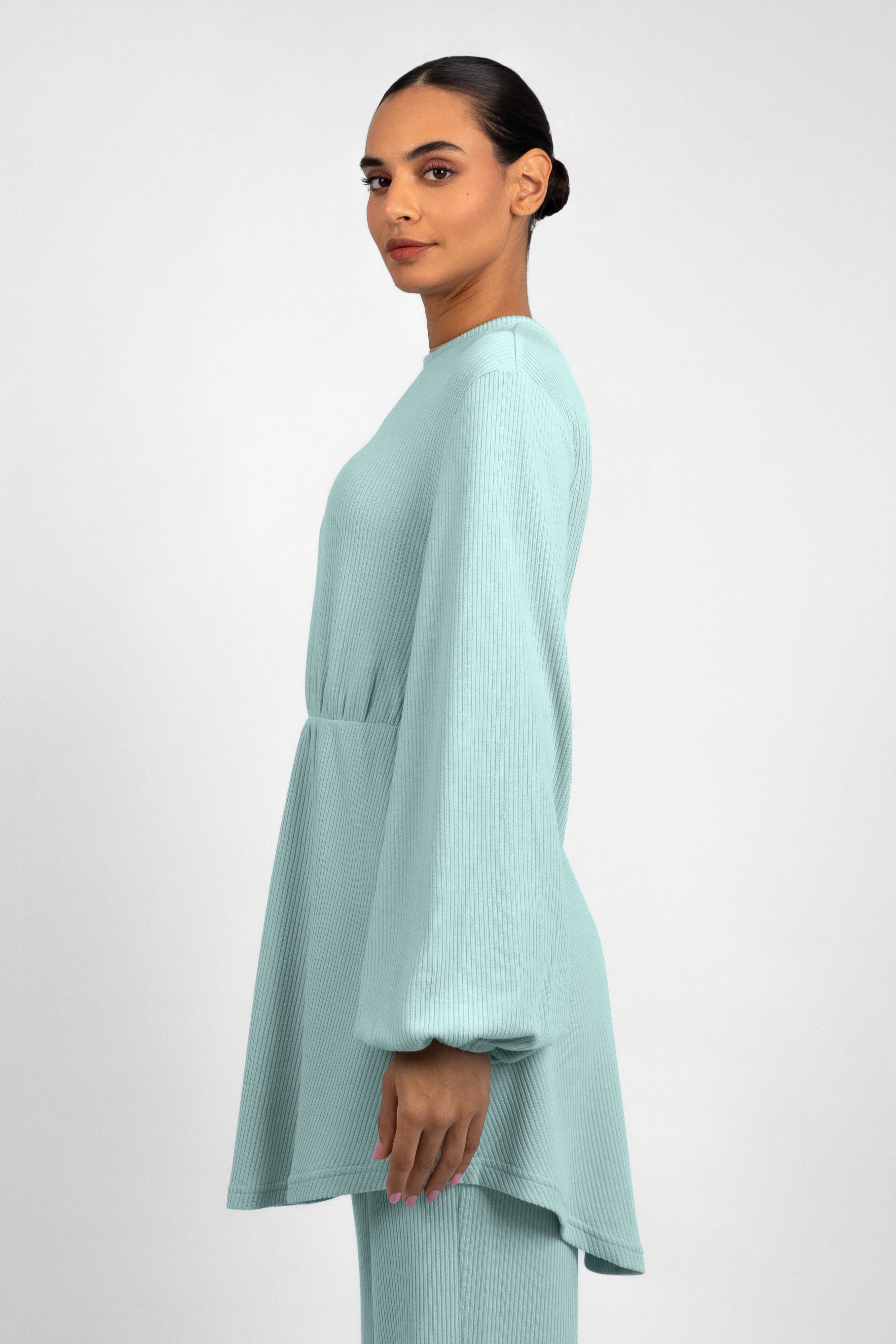 Colour: Icy: Blue. A side pose from a girl in a Knit Peplum Top.