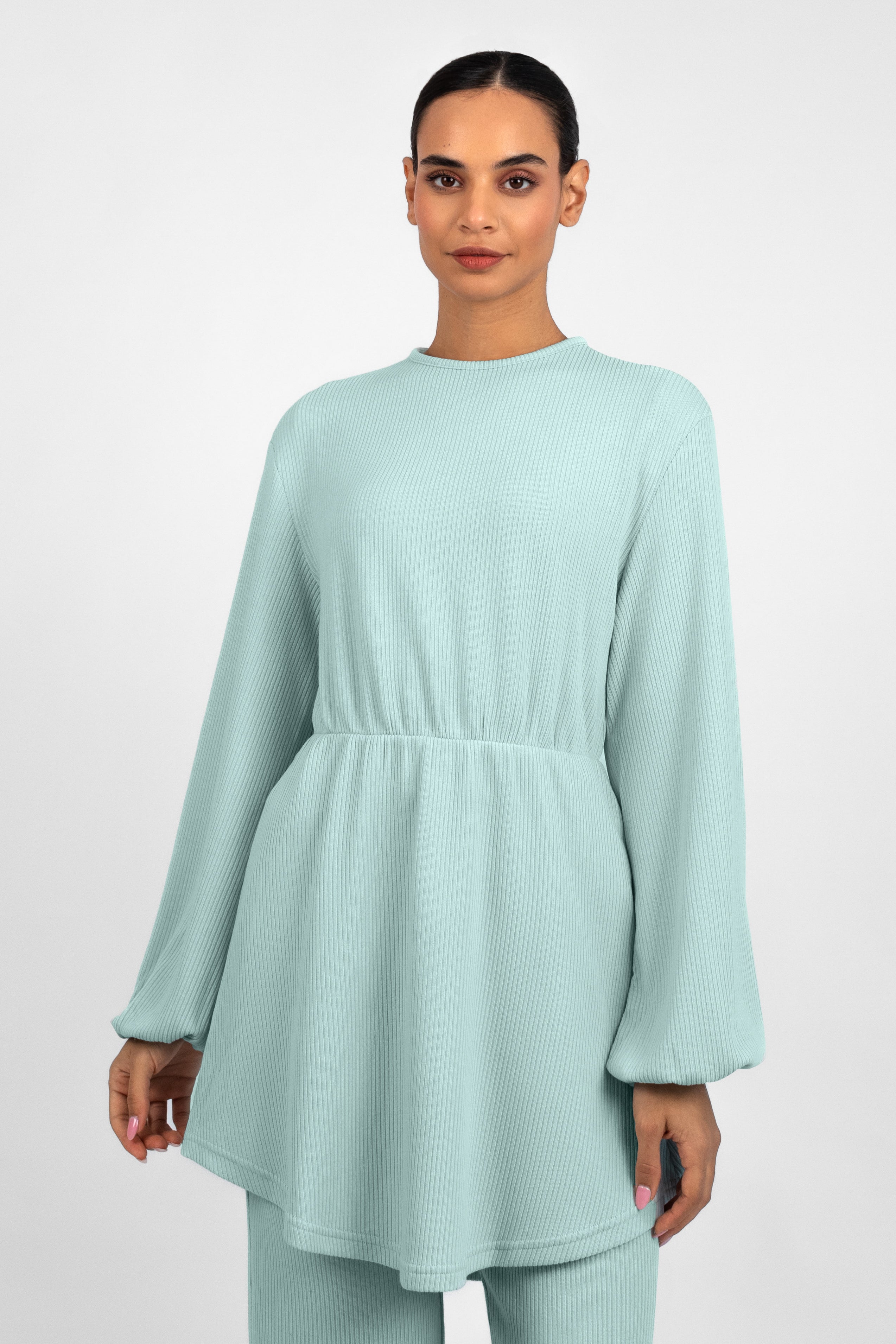 A closer front pose froma  girl in a Knit Peplum Top.	Colour: Icy: Blue