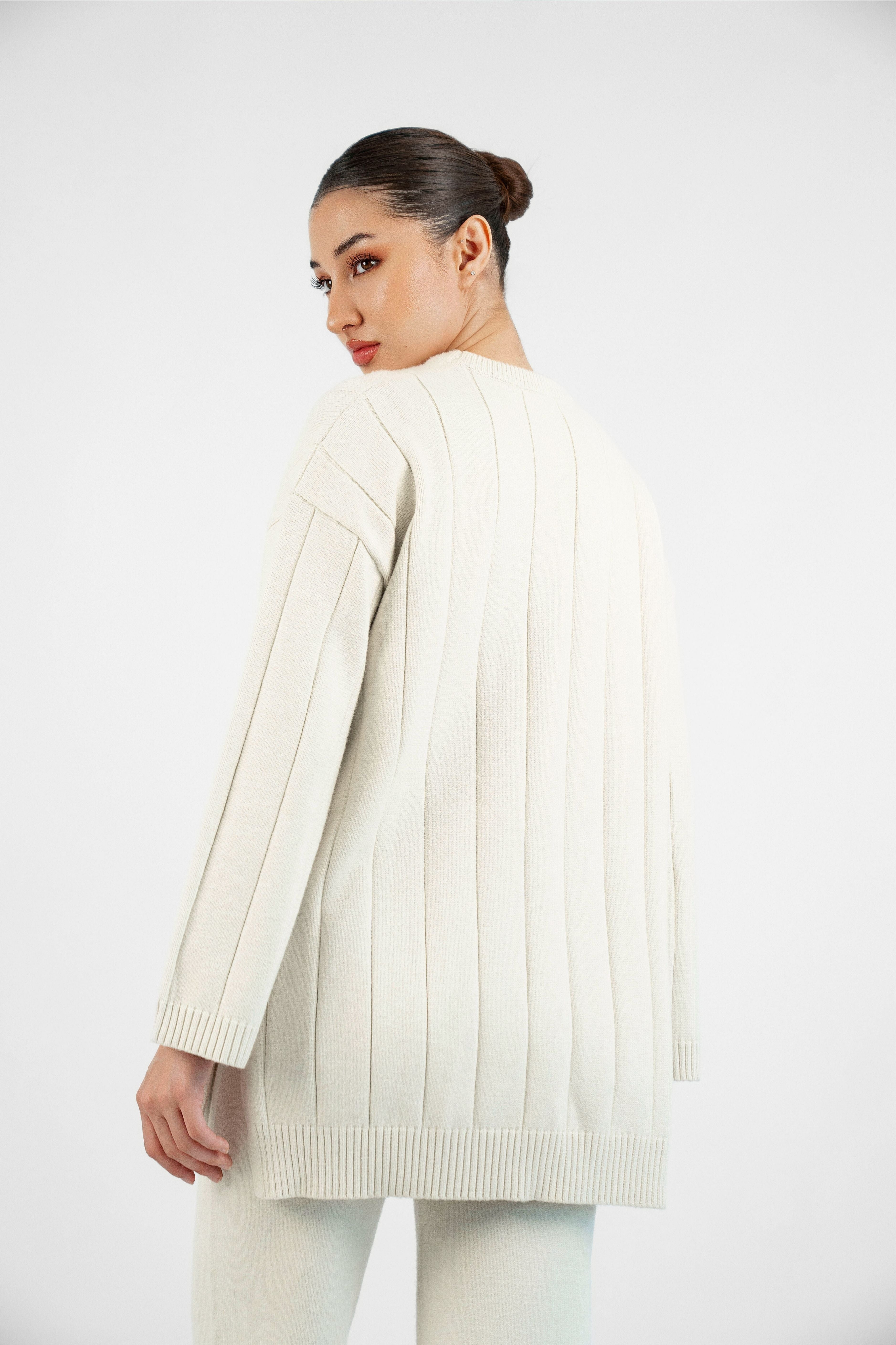 Colour: Cream. A model from behind wearing a Cloud Knit Sweater